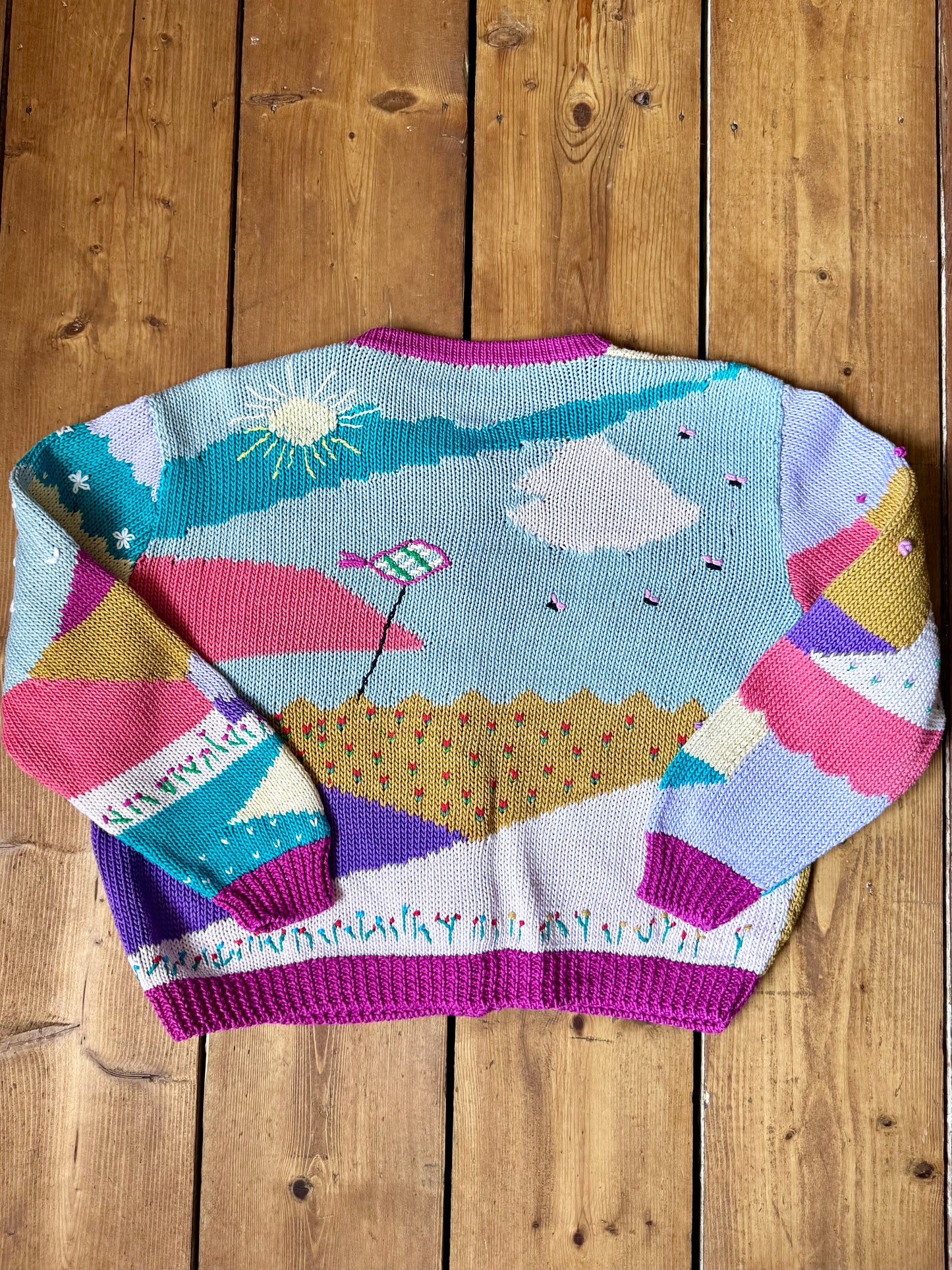 One-of-a-kind vintage kid's cardigan with embroidered countryside scenes and heart buttons. A colourful nostalgic knit, handpicked for Bee Tiny kids vintage.