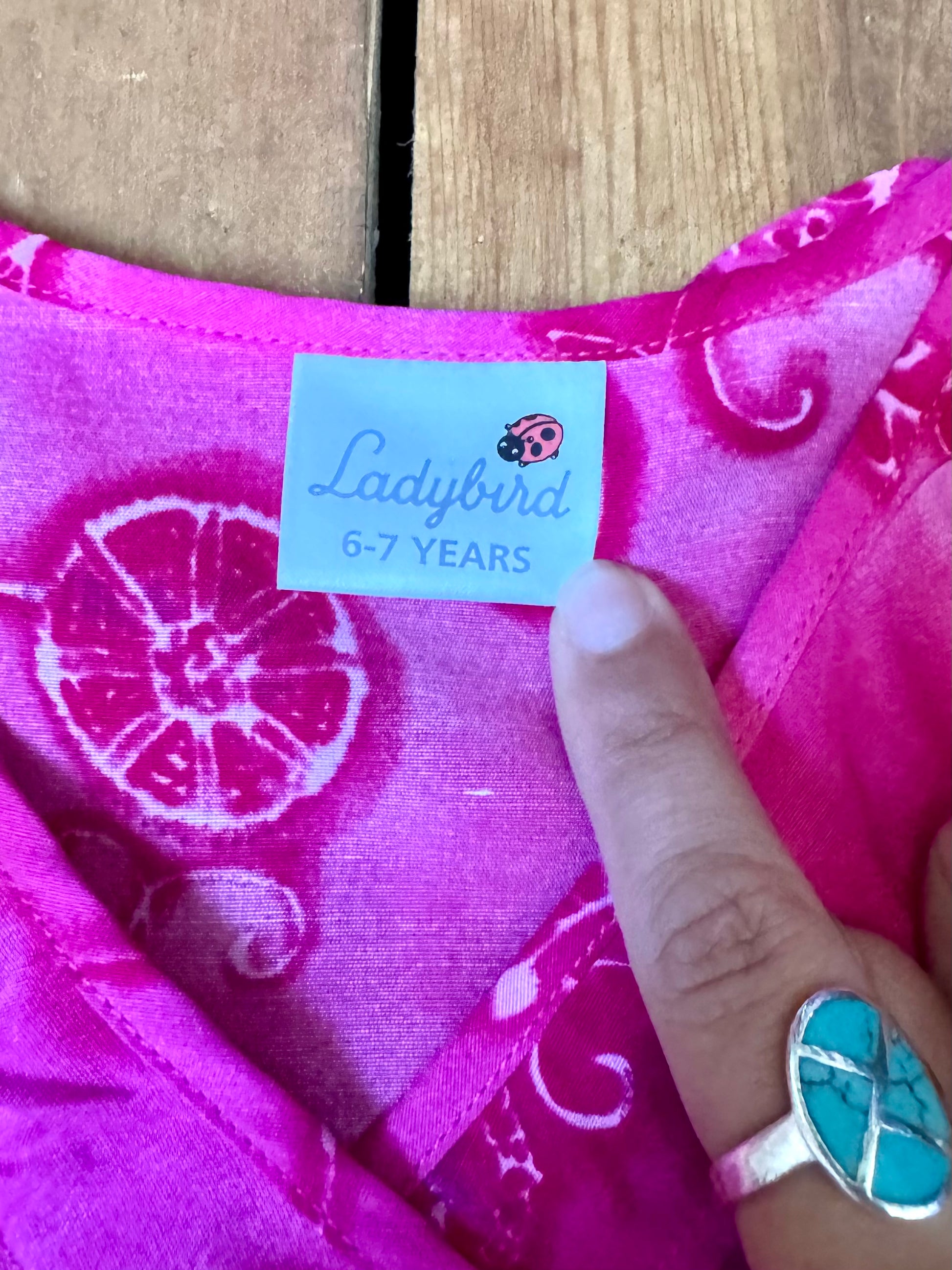 Vintage Y2K fuchsia floral occasion dress for kids. Lightweight 100% viscose with wrap neckline and fluted hem. Handpicked for Bee Tiny kids vintage.