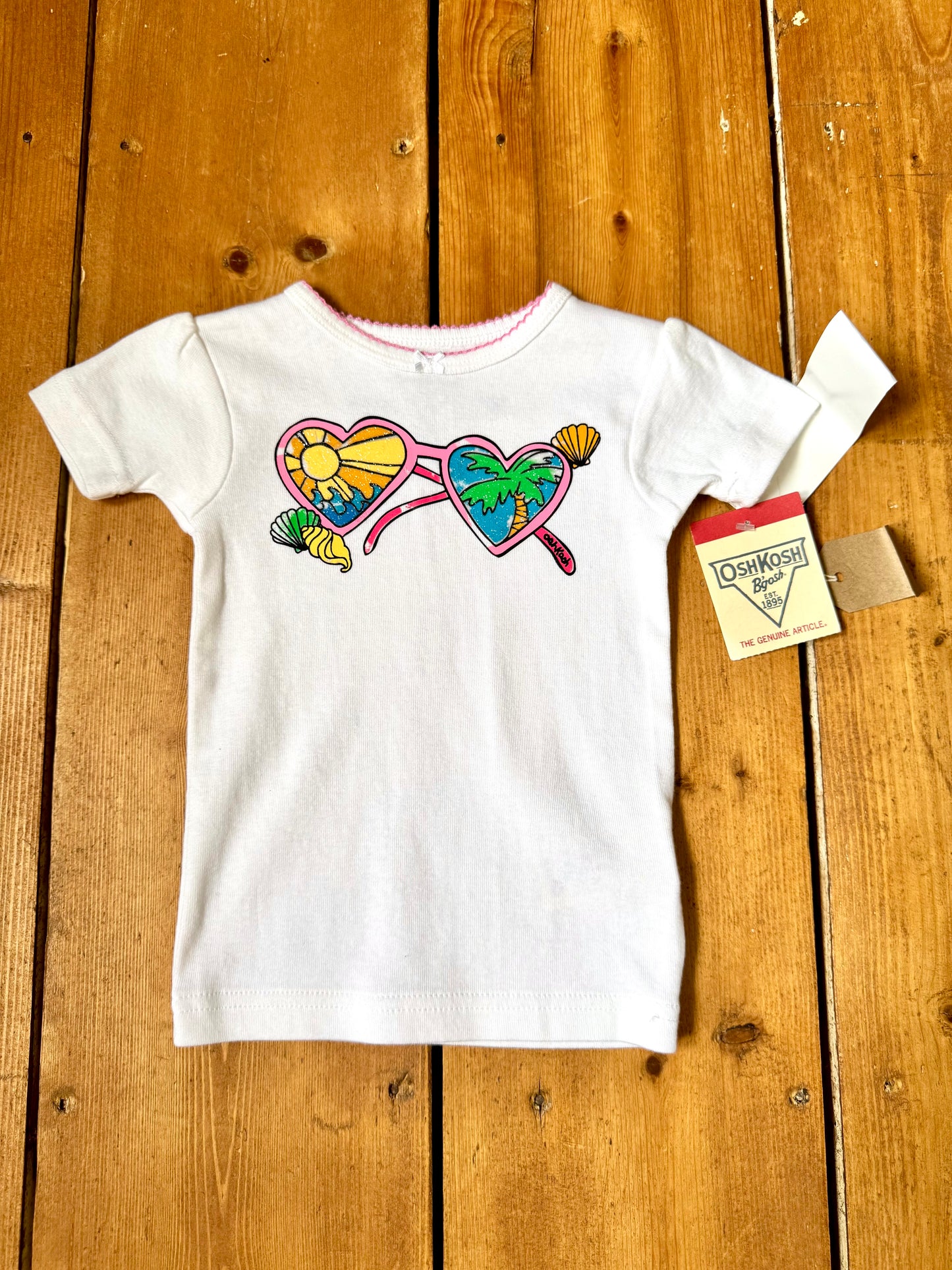 Deadstock OshKosh Y2K T-shirt with tropical heart sunglasses graphic. Authentic vintage kidswear with original tags. Handpicked for Bee Tiny kids vintage.