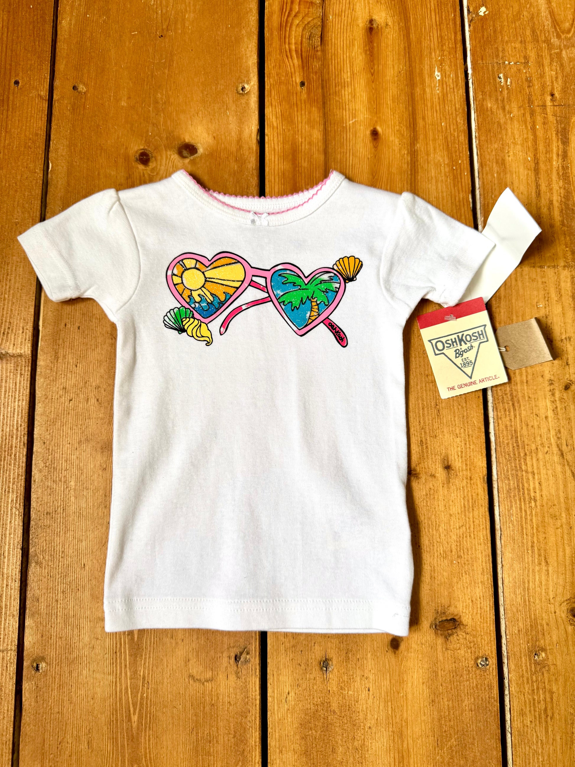 Deadstock OshKosh Y2K T-shirt with tropical heart sunglasses graphic. Authentic vintage kidswear with original tags. Handpicked for Bee Tiny kids vintage.