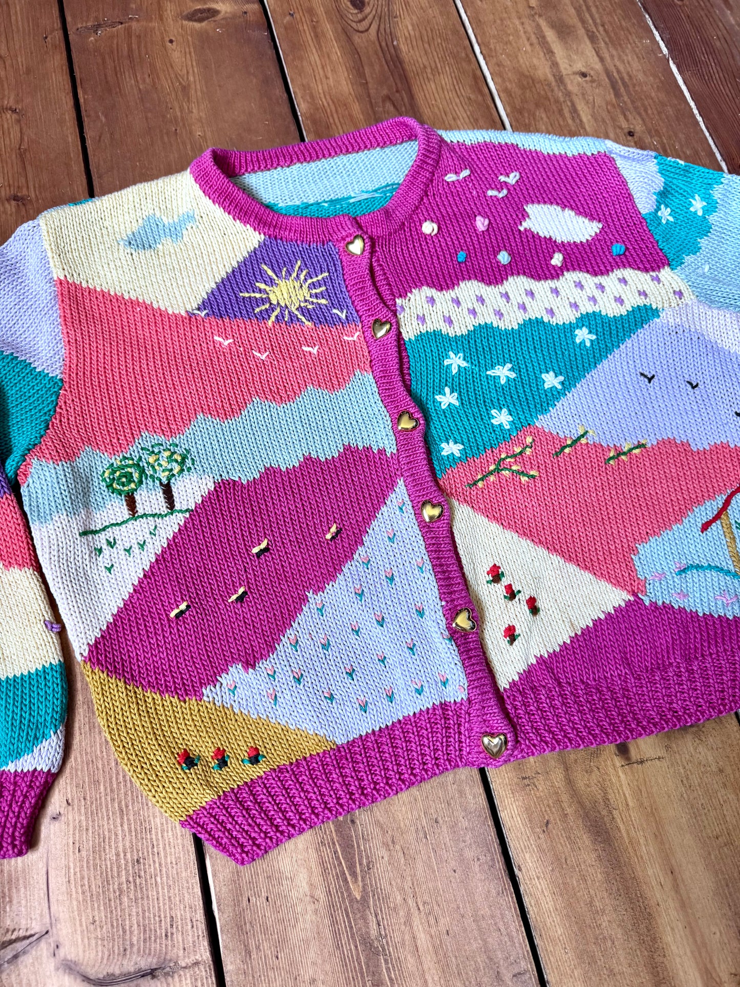 One-of-a-kind vintage kid's cardigan with embroidered countryside scenes and heart buttons. A colourful nostalgic knit, handpicked for Bee Tiny kids vintage.