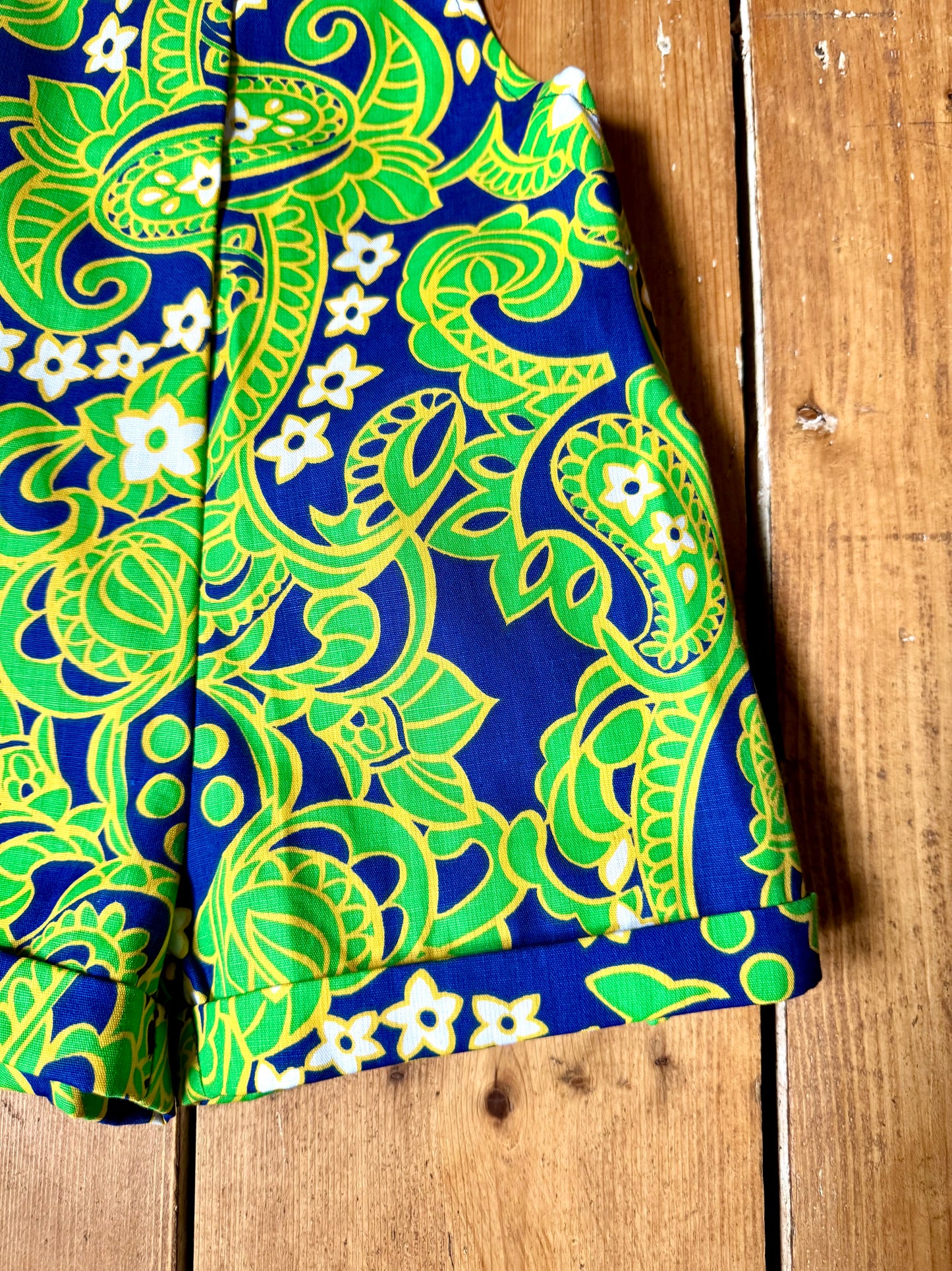 Vintage 70s green romper, dungaree shorts. Psychedelic print dungaree shorts. Handpicked for Bee Tiny kids vintage. 