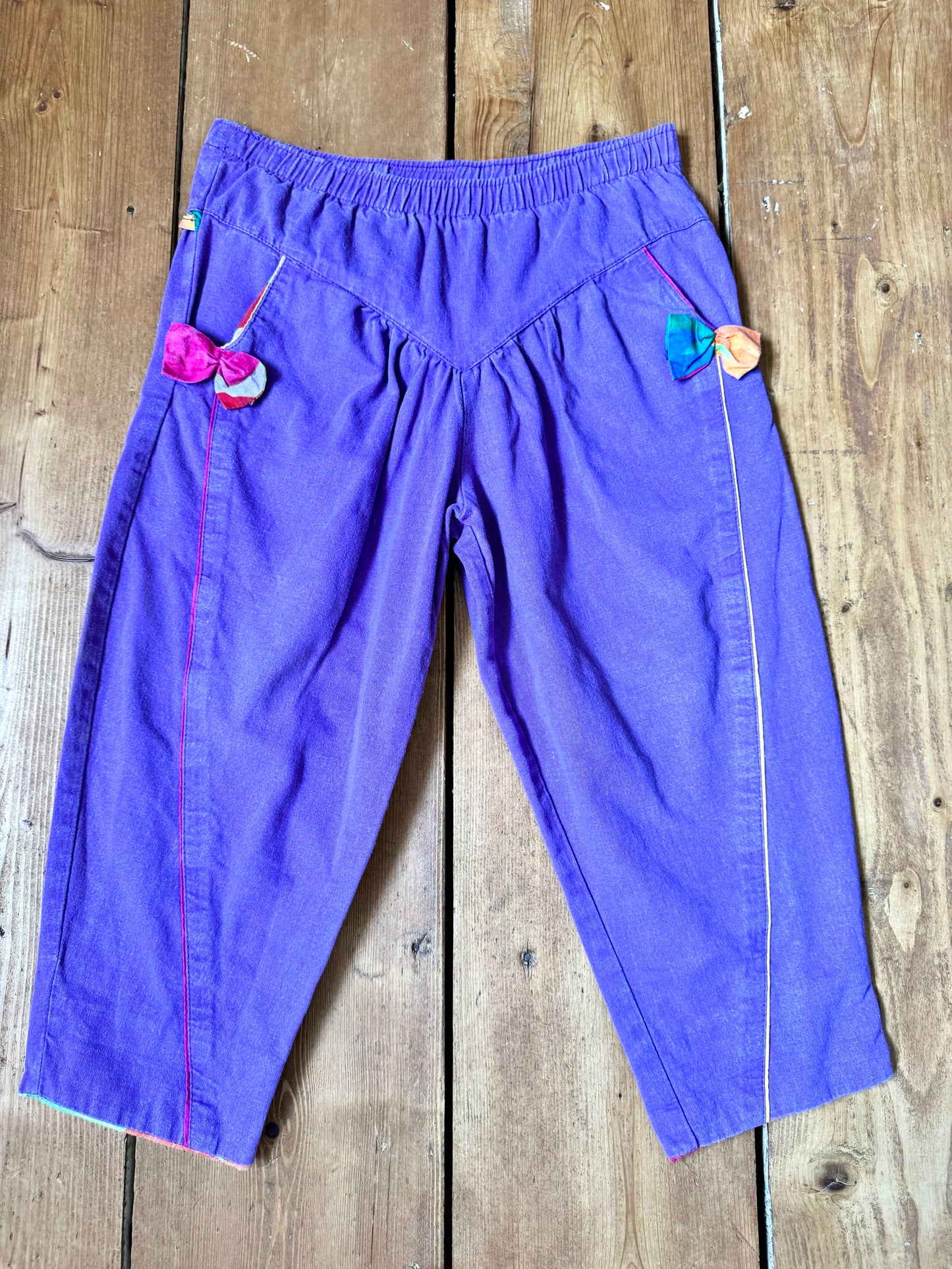 Vintage 80s purple children's trousers with rainbow details from the late 80s/early 90s. Bright, playful and handpicked for Bee Tiny kids vintage.