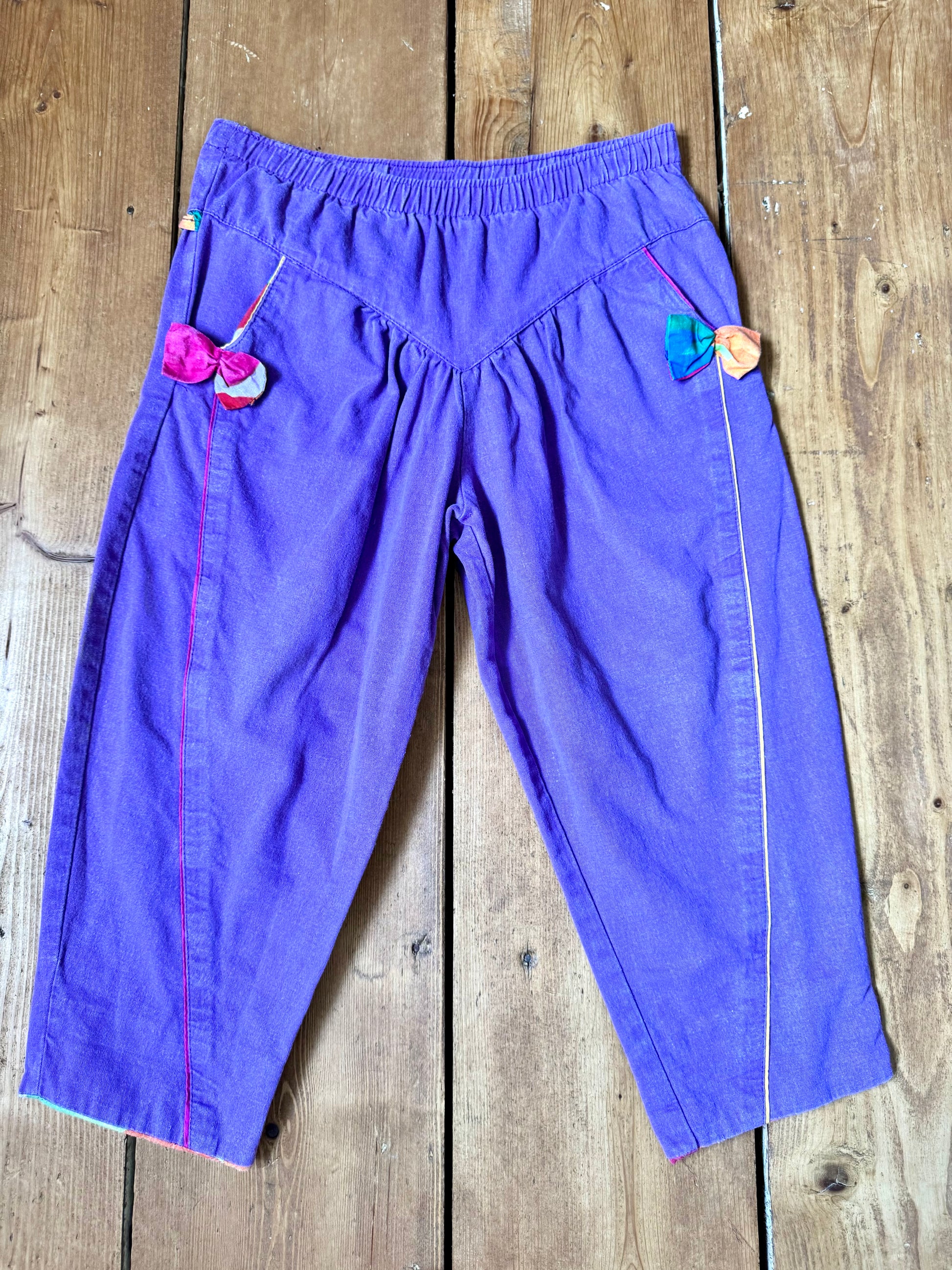 Vintage 80s purple children's trousers with rainbow details from the late 80s/early 90s. Bright, playful and handpicked for Bee Tiny kids vintage.