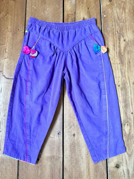 Vintage 80s purple children's trousers with rainbow details from the late 80s/early 90s. Bright, playful and handpicked for Bee Tiny kids vintage.
