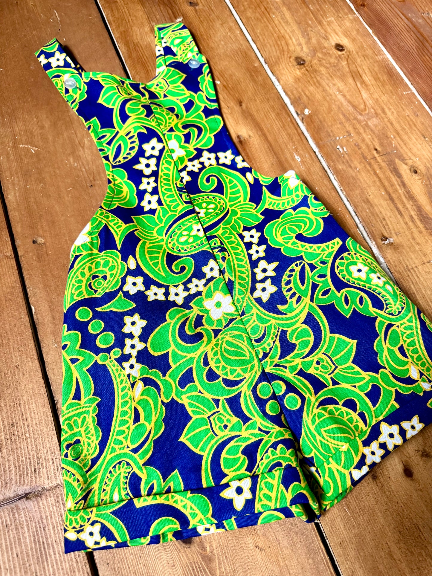 Vintage 70s green romper, dungaree shorts. Psychedelic print dungaree shorts. Handpicked for Bee Tiny kids vintage. 