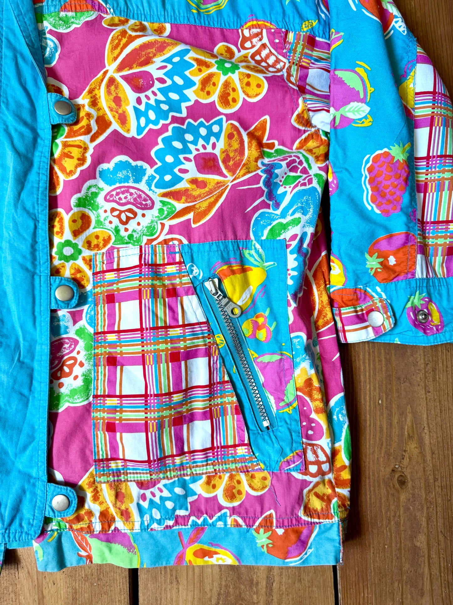 Vintage 90s reversible kids hooded jacket featuring colourful tropical floral prints and a turquoise reverse. Kids vintage lightweight summer coat. Handpicked for Bee Tiny kids vintage.