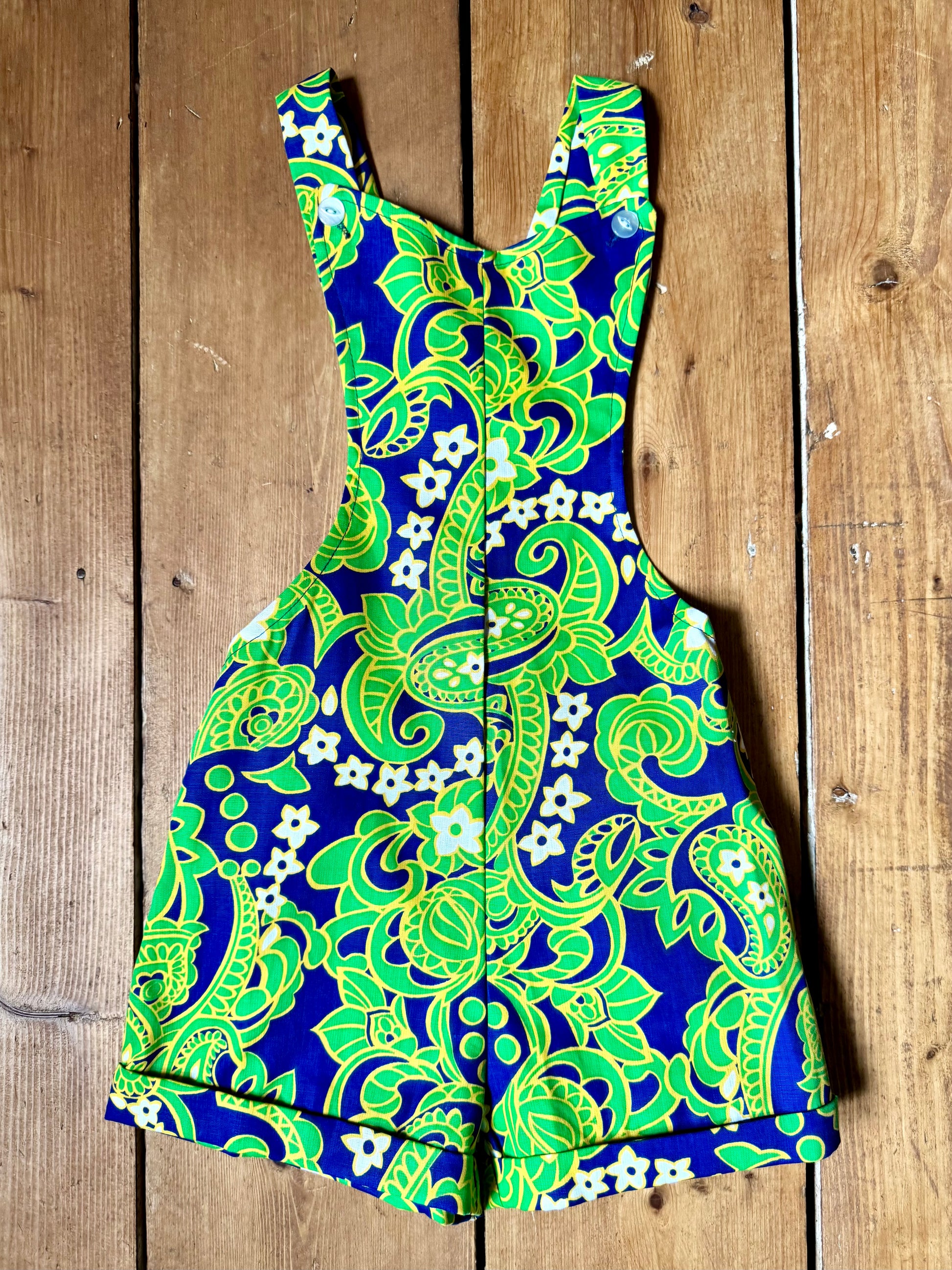 Vintage 70s green romper, dungaree shorts. Psychedelic print dungaree shorts. Handpicked for Bee Tiny kids vintage. 