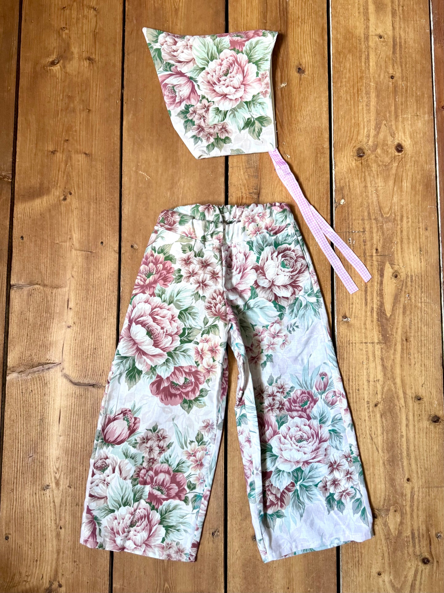 Handmade vintage floral children's set featuring wide-leg trousers and a matching pixie bonnet. One-of-a-kind, sustainably made from rescued fabric. Handmade for Bee Tiny kids vintage.