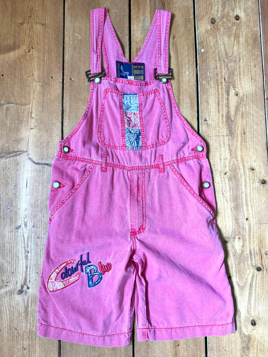 Vintage 90s pink dungaree shorts with paisley patchwork detailing. A colourful summer vintage favourite for kids. Handpicked for Bee Tiny kids vintage. 