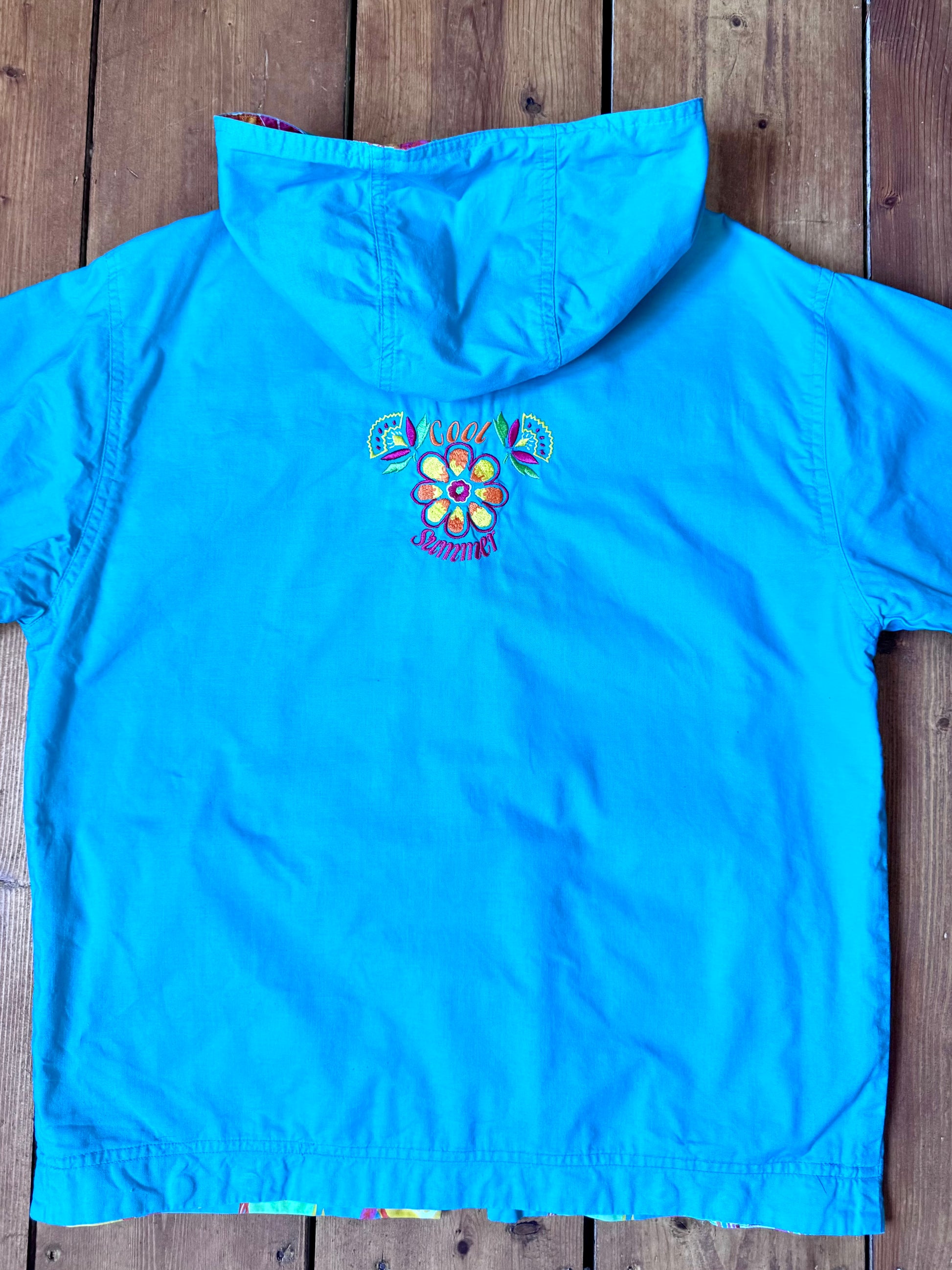 Vintage 90s reversible kids hooded jacket featuring colourful tropical floral prints and a turquoise reverse. Kids vintage lightweight summer coat. Handpicked for Bee Tiny kids vintage.