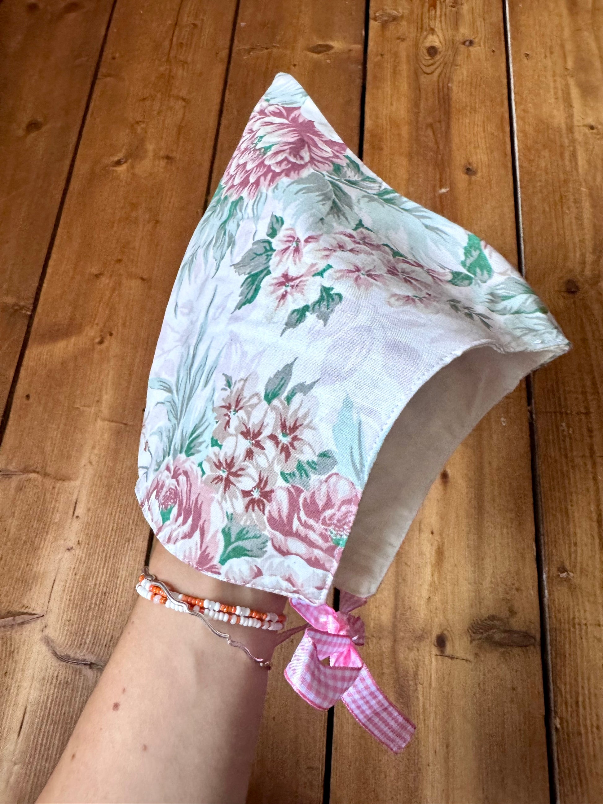 Handmade vintage floral children's set featuring wide-leg trousers and a matching pixie bonnet. One-of-a-kind, sustainably made from rescued fabric.