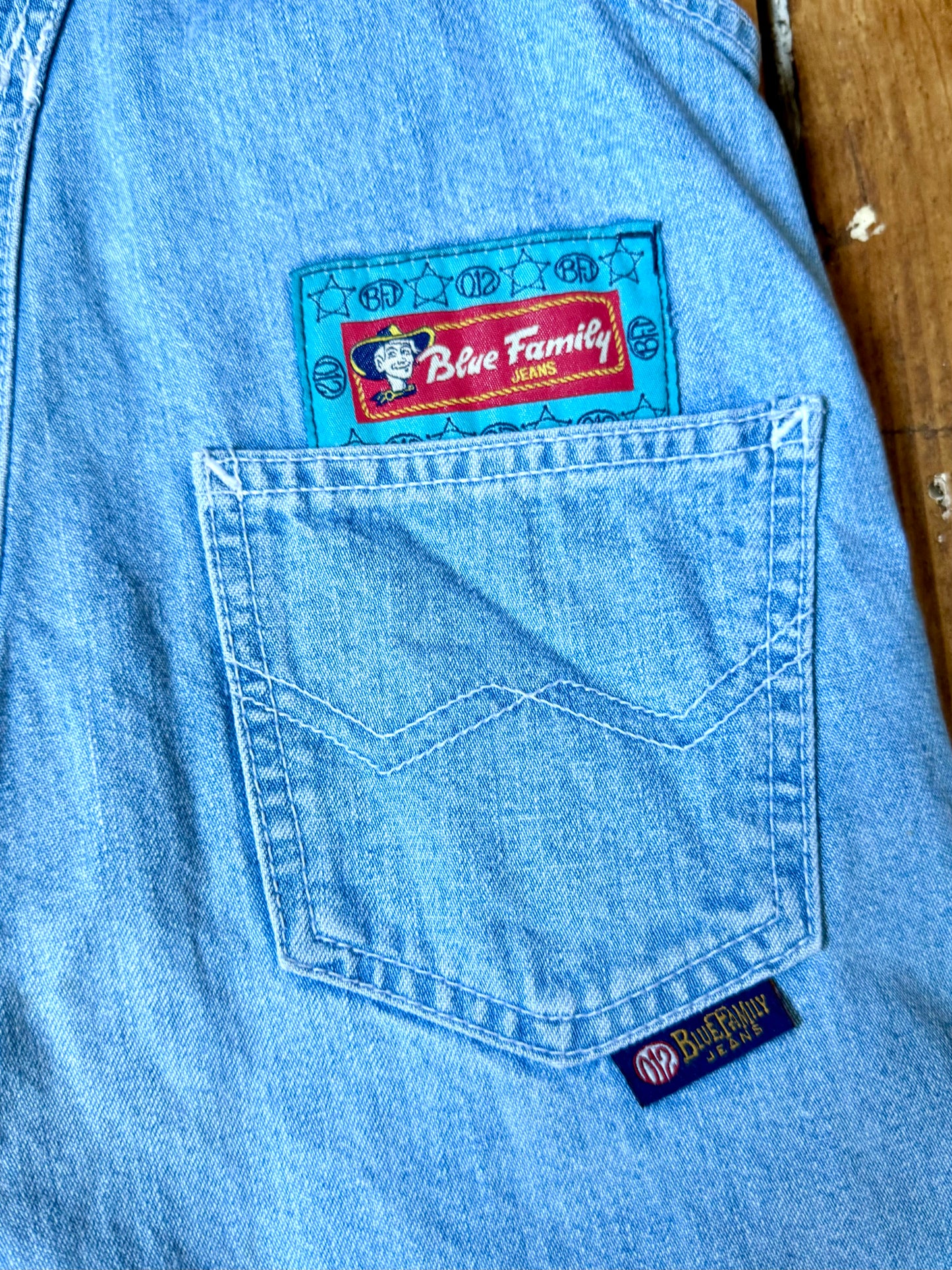 Authentic 90s Blue Family denim short dungarees with adjustable straps, embroidered branding and classic light wash denim. Perfect vintage summer style. Handpicked for Bee Tiny kids vintage. Vintage 90s shortalls.