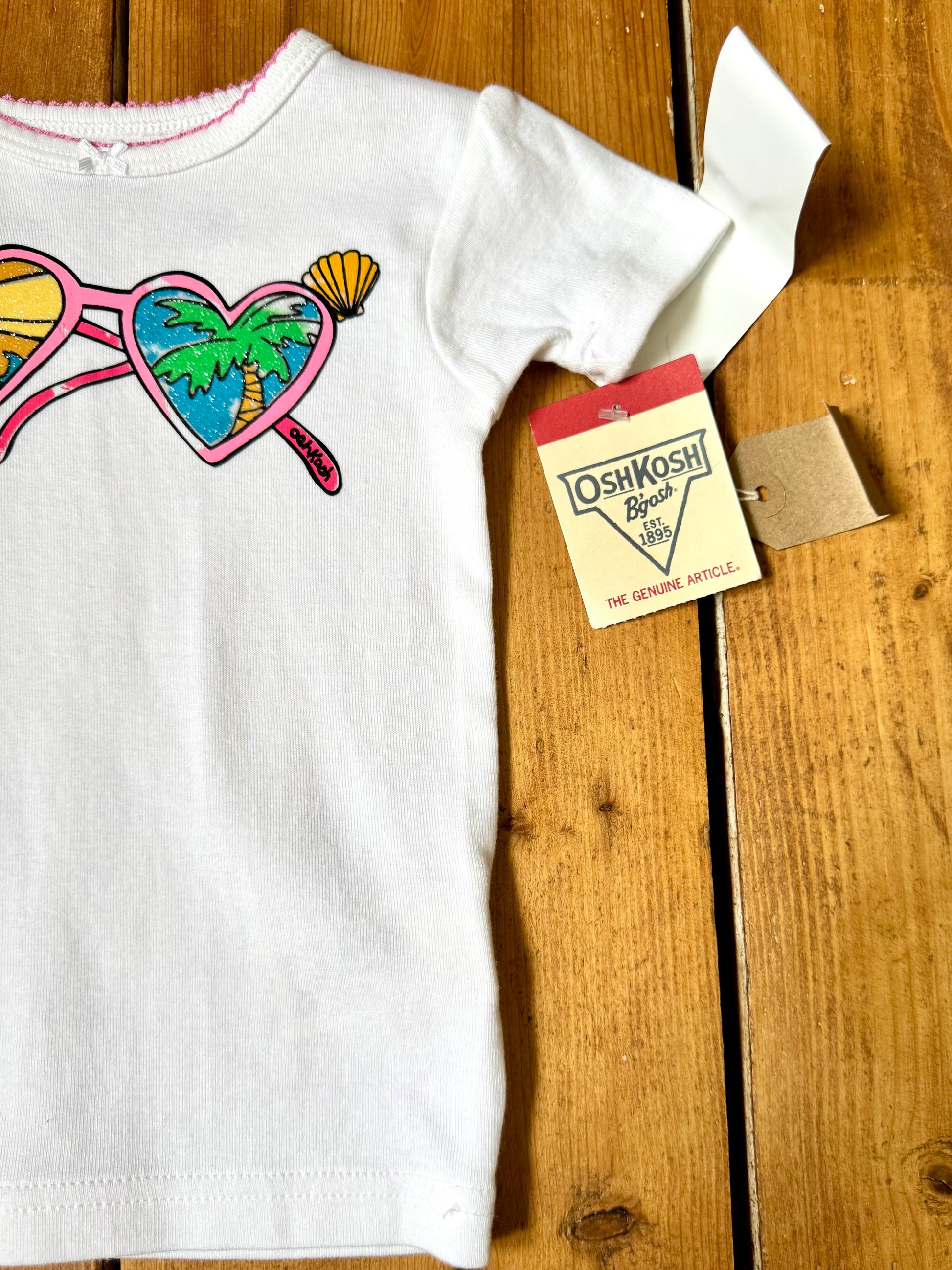 Deadstock OshKosh Y2K T-shirt with tropical heart sunglasses graphic. Authentic vintage kidswear with original tags. Handpicked for Bee Tiny kids vintage.
