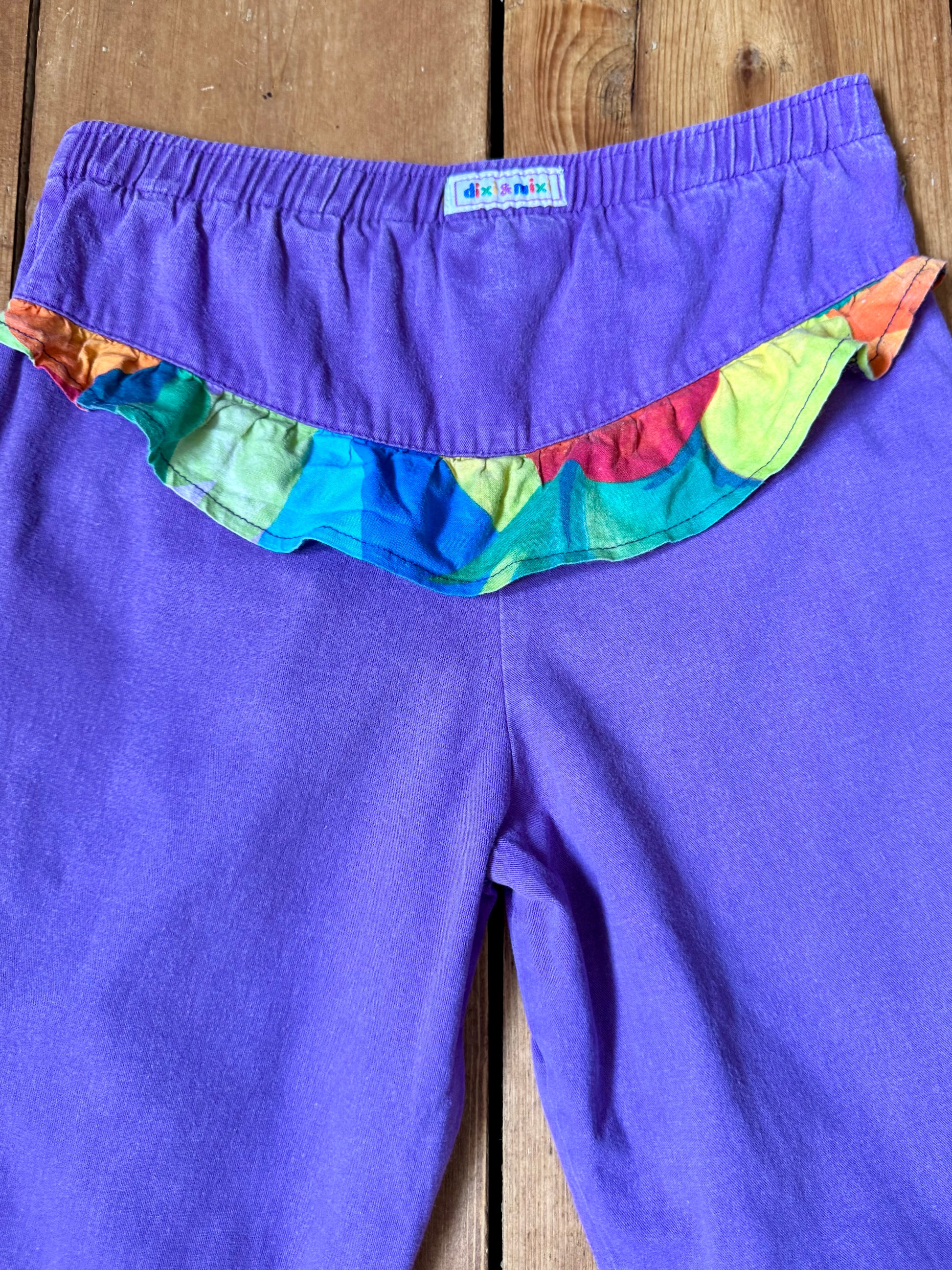 Vintage 80s purple children's trousers with rainbow details from the late 80s/early 90s. Bright, playful and handpicked for Bee Tiny kids vintage.