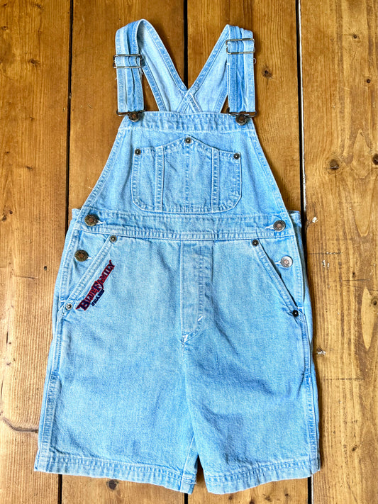 Authentic 90s Blue Family denim short dungarees with adjustable straps, embroidered branding and classic light wash denim. Perfect vintage summer style. Handpicked for Bee Tiny kids vintage. Vintage 90s shortalls.