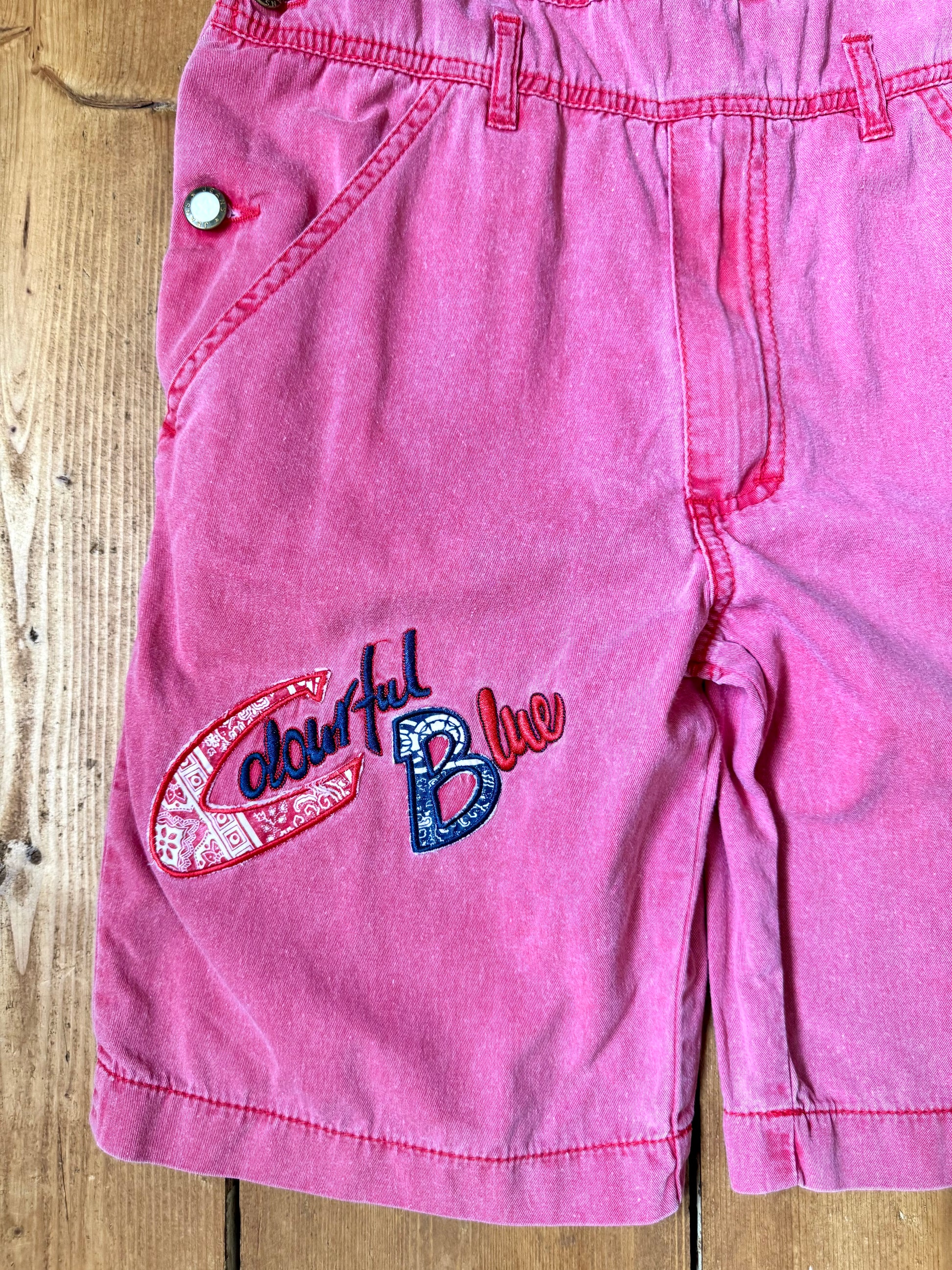 Vintage 90s pink dungaree shorts with paisley patchwork detailing. A colourful summer vintage favourite for kids. Handpicked for Bee Tiny kids vintage. 