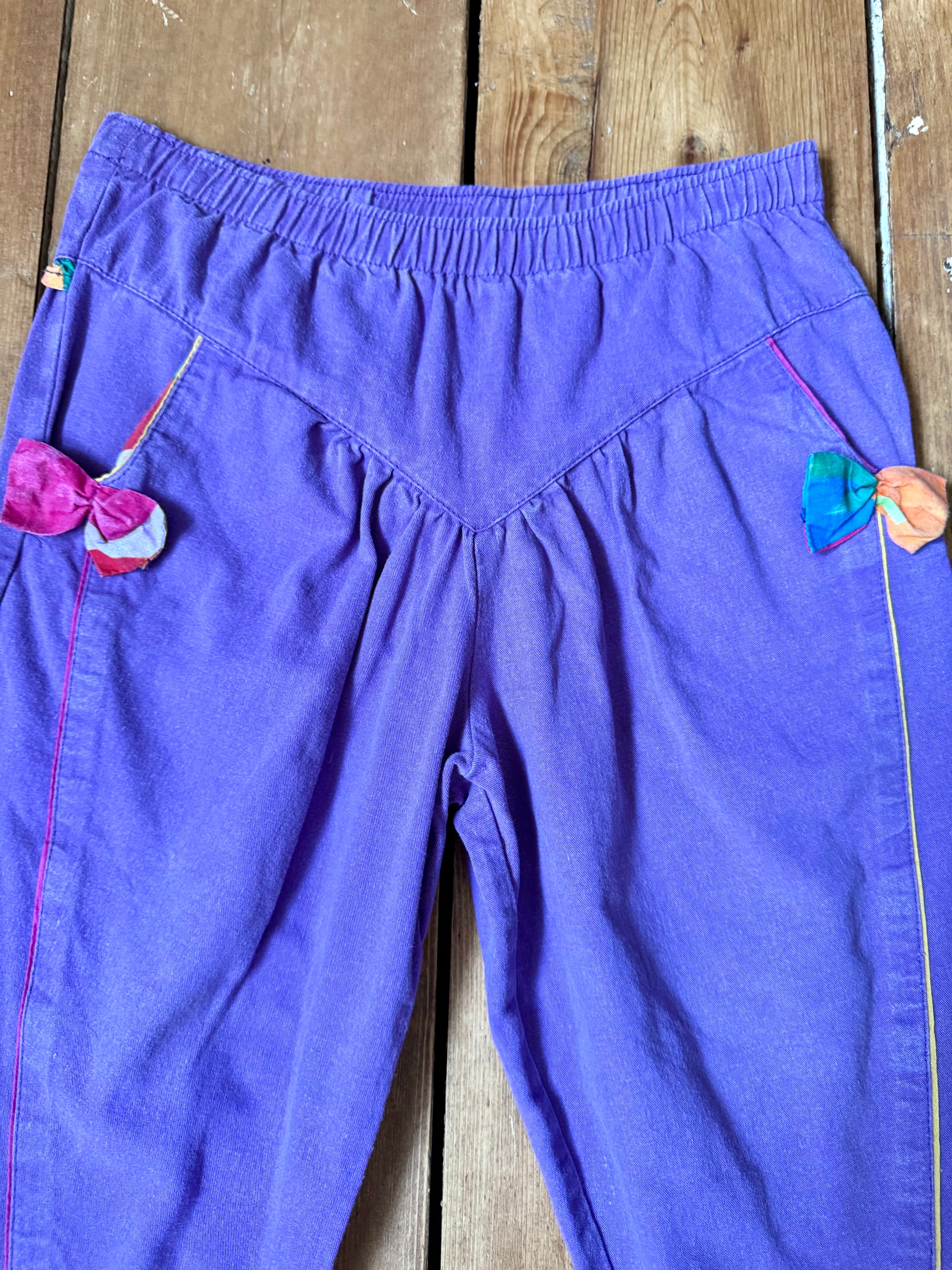 Vintage 80s purple children's trousers with rainbow details from the late 80s/early 90s. Bright, playful and handpicked for Bee Tiny kids vintage.