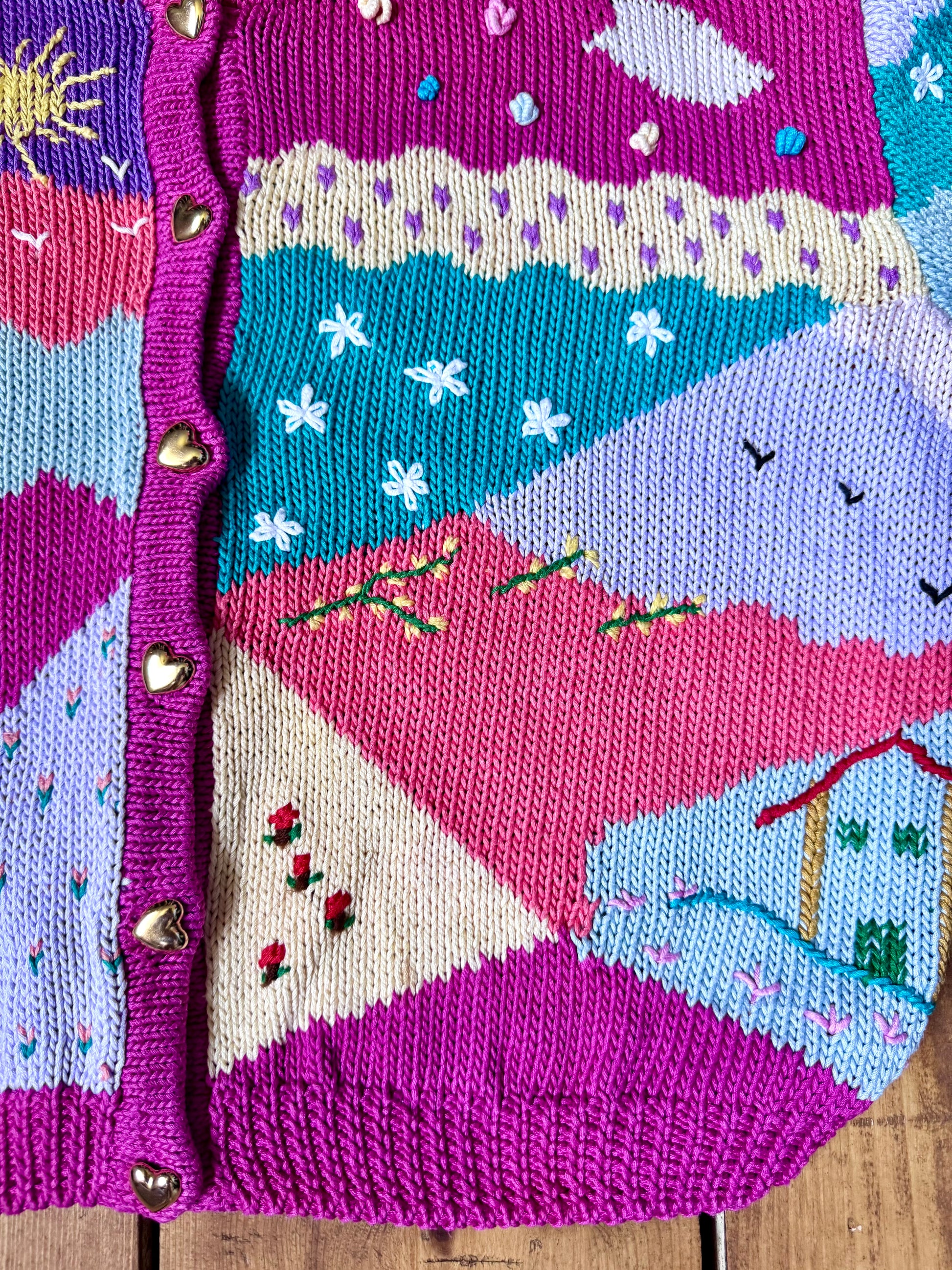 One-of-a-kind vintage kid's cardigan with embroidered countryside scenes and heart buttons. A colourful nostalgic knit, handpicked for Bee Tiny kids vintage.