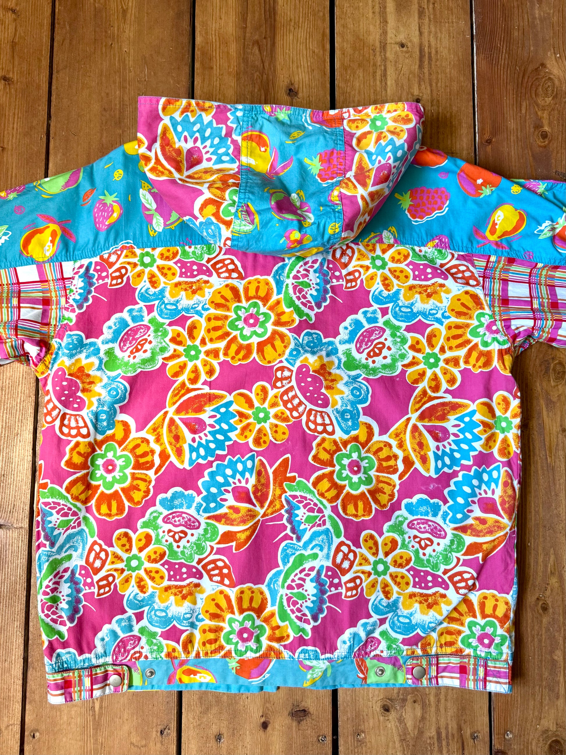 Vintage 90s reversible kids hooded jacket featuring colourful tropical floral prints and a turquoise reverse. Kids vintage lightweight summer coat. Handpicked for Bee Tiny kids vintage.