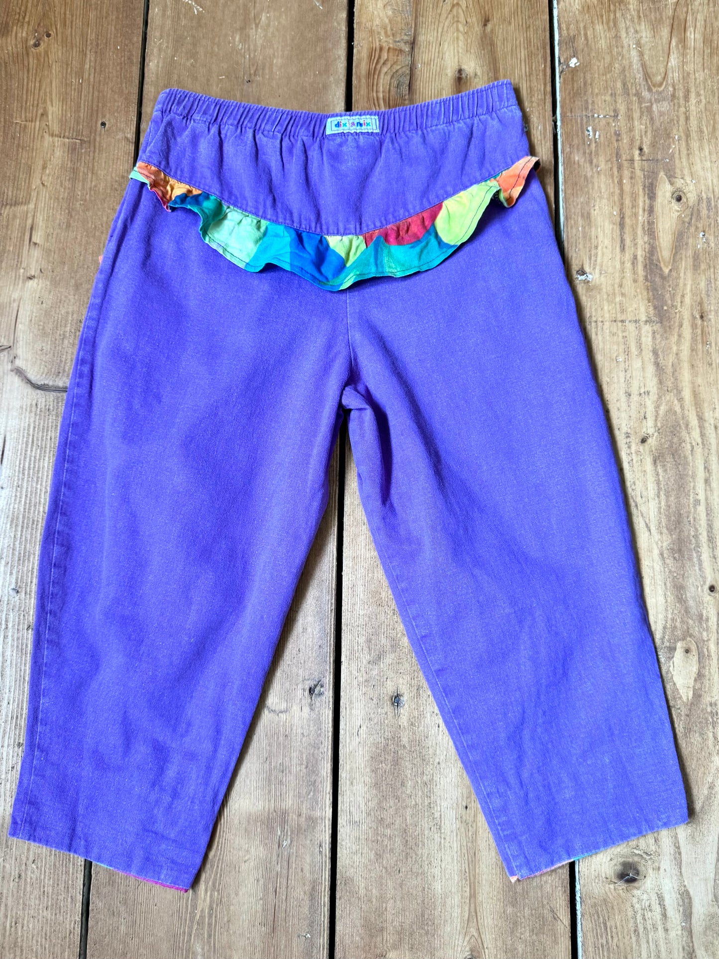 Vintage 80s purple children's trousers with rainbow details from the late 80s/early 90s. Bright, playful and handpicked for Bee Tiny kids vintage.