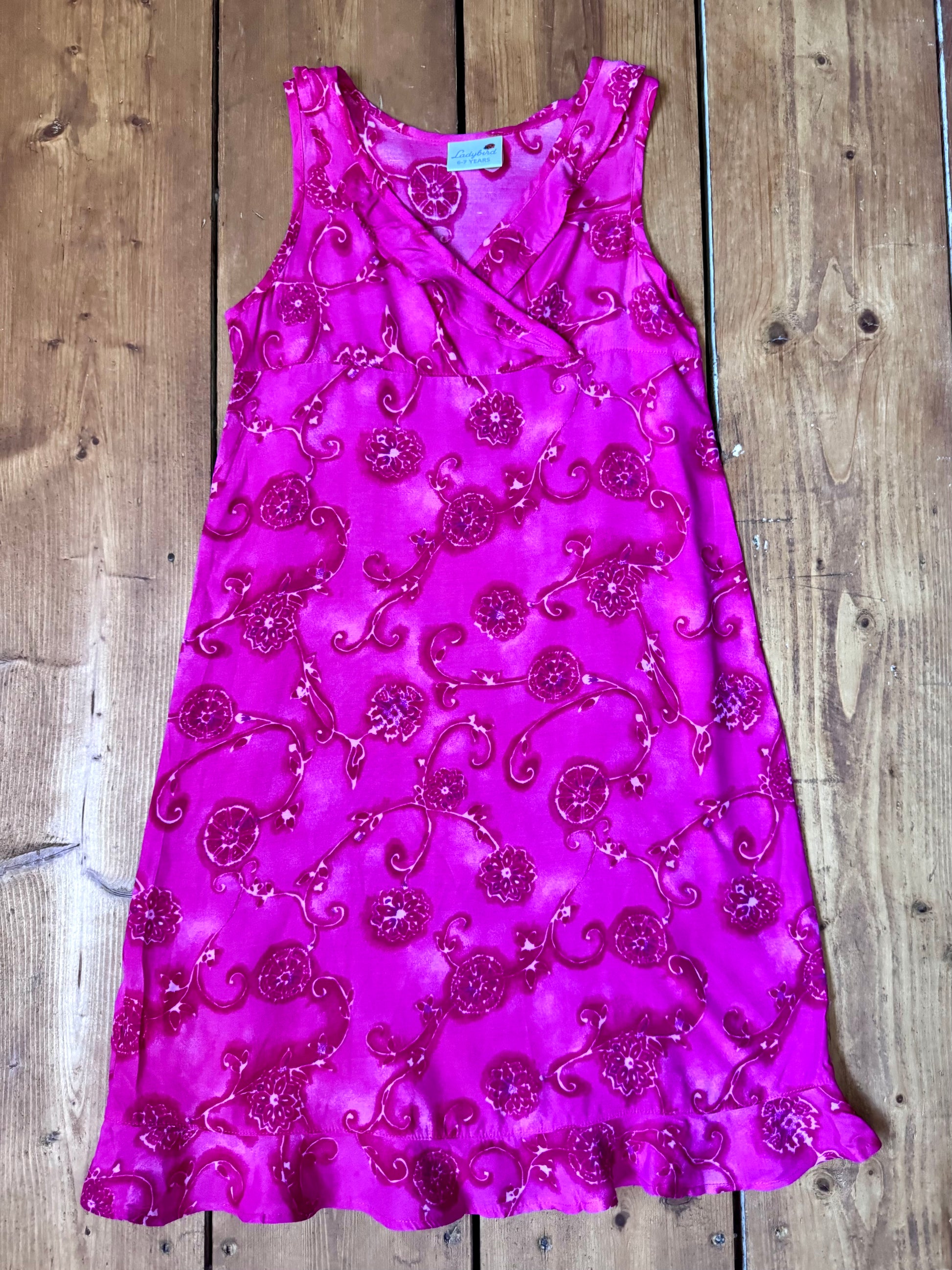 Vintage Y2K fuchsia floral occasion dress for kids. Lightweight 100% viscose with wrap neckline and fluted hem. Handpicked for Bee Tiny kids vintage.
