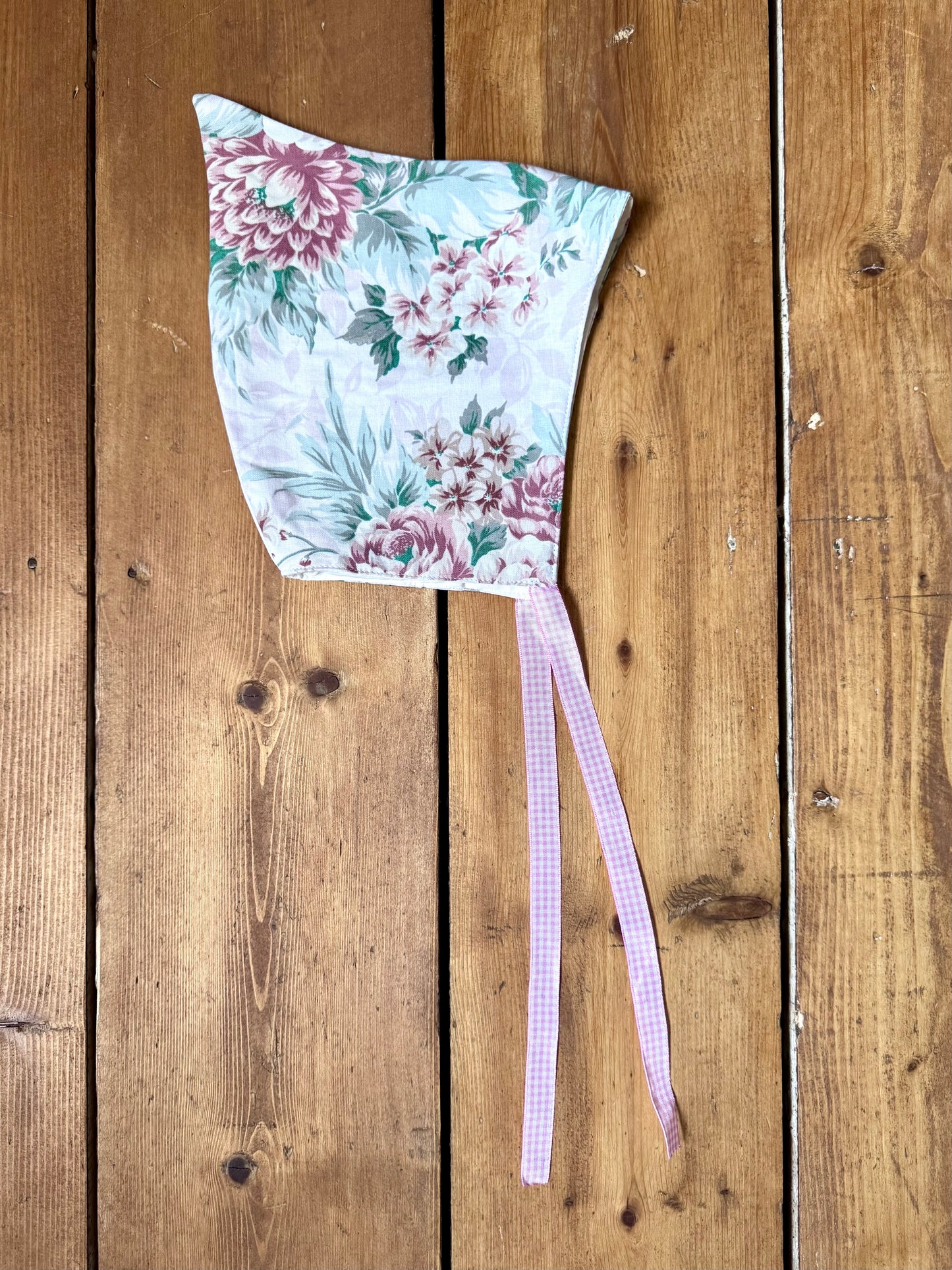 Handmade vintage floral children's set featuring wide-leg trousers and a matching pixie bonnet. One-of-a-kind, sustainably made from rescued fabric.