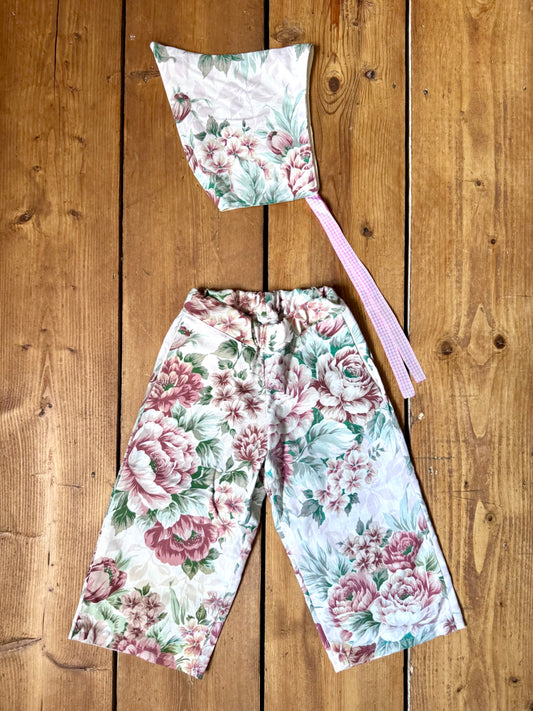 Handmade vintage floral children's set featuring wide-leg trousers and a matching pixie bonnet. One-of-a-kind, sustainably made from rescued fabric. Handmade for Bee Tiny kids vintage.