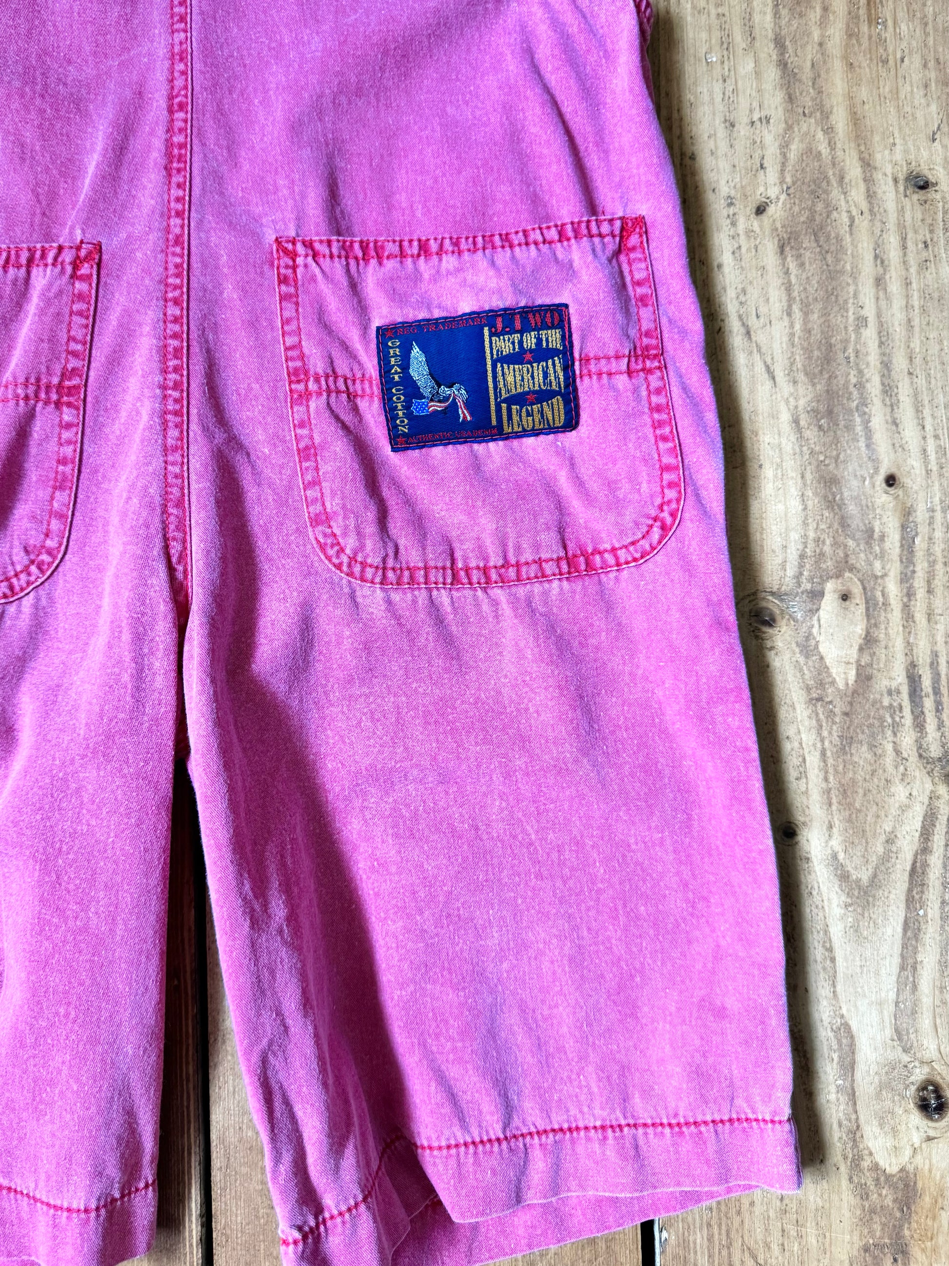 Vintage 90s pink dungaree shorts with paisley patchwork detailing. A colourful summer vintage favourite for kids. Handpicked for Bee Tiny kids vintage. 