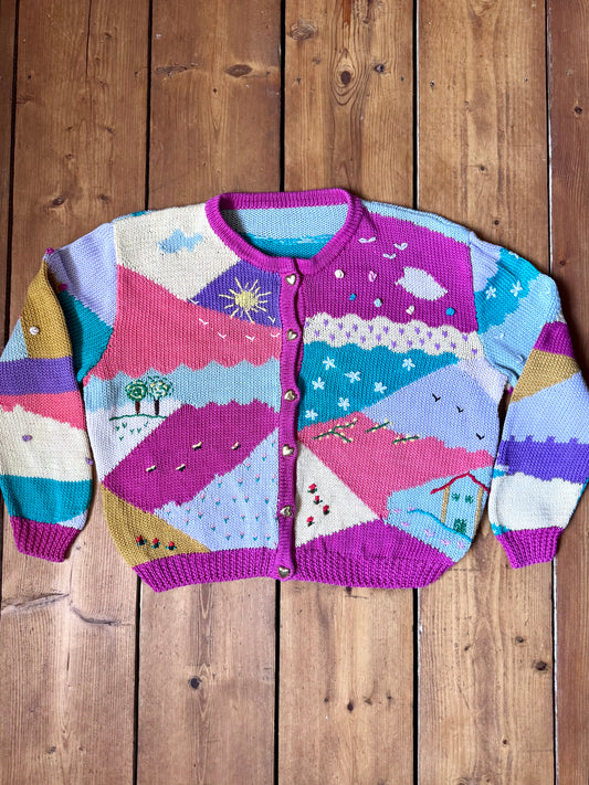 One-of-a-kind vintage kid's cardigan with embroidered countryside scenes and heart buttons. A colourful nostalgic knit, handpicked for Bee Tiny kids vintage.