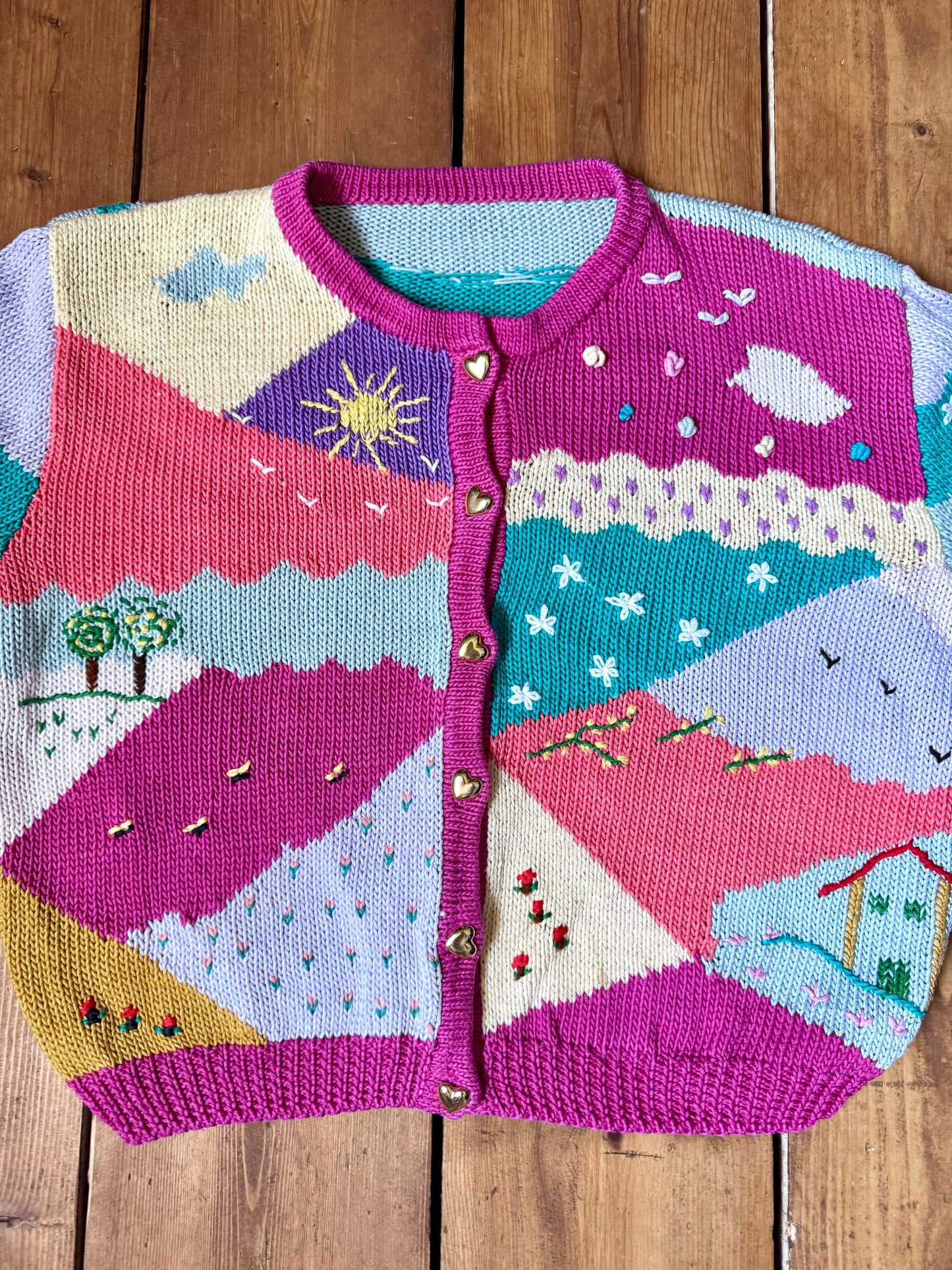 One-of-a-kind vintage kid's cardigan with embroidered countryside scenes and heart buttons. A colourful nostalgic knit, handpicked for Bee Tiny kids vintage.
