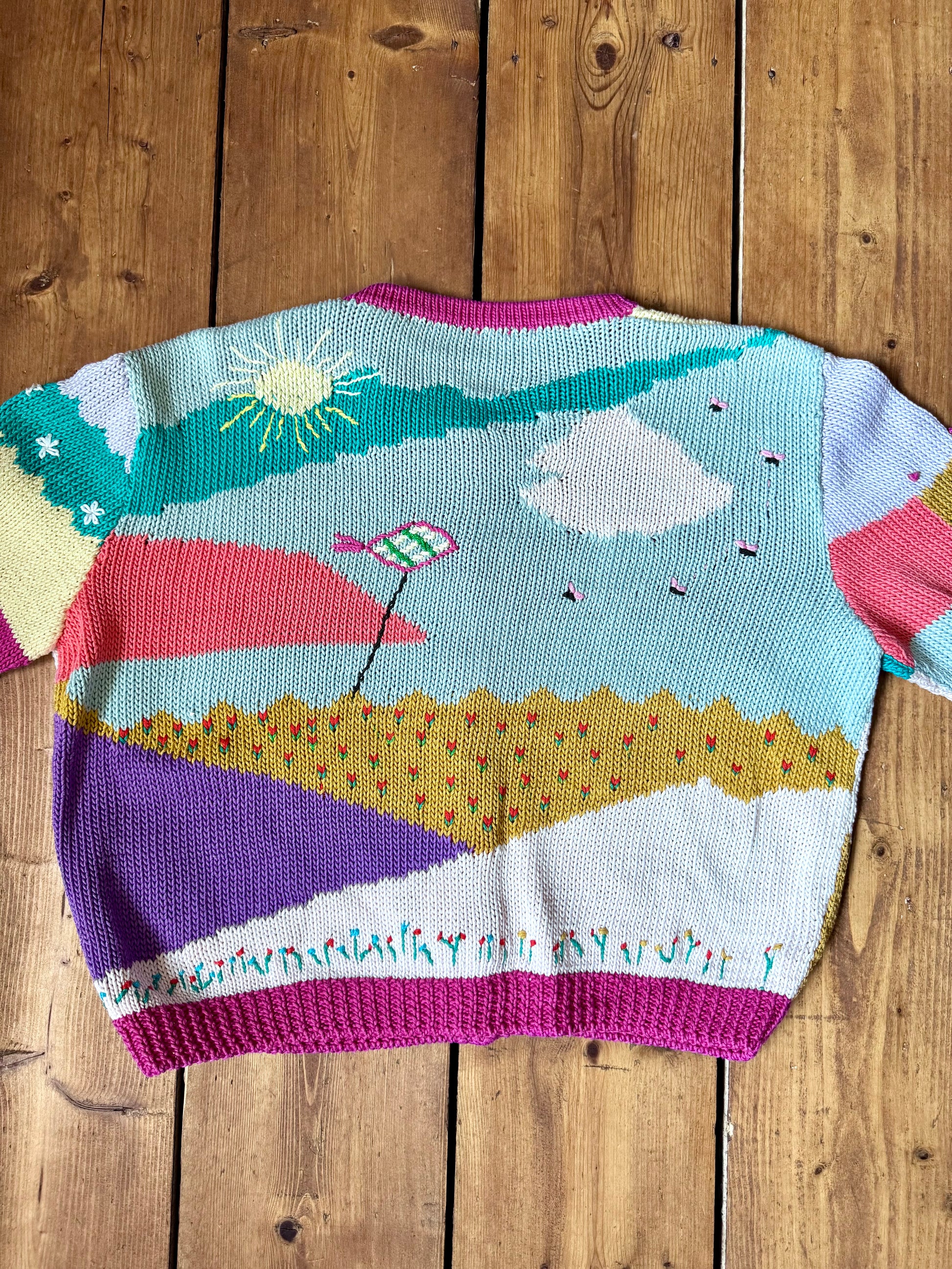 One-of-a-kind vintage kid's cardigan with embroidered countryside scenes and heart buttons. A colourful nostalgic knit, handpicked for Bee Tiny kids vintage.