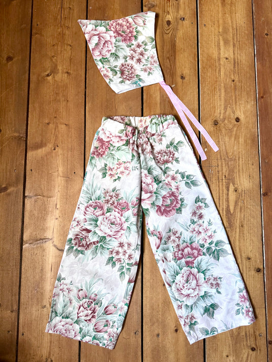 Handmade vintage floral children's set featuring wide-leg trousers and a matching pixie bonnet. One-of-a-kind, sustainably made from rescued fabric. Handmade for Bee Tiny kids vintage.
