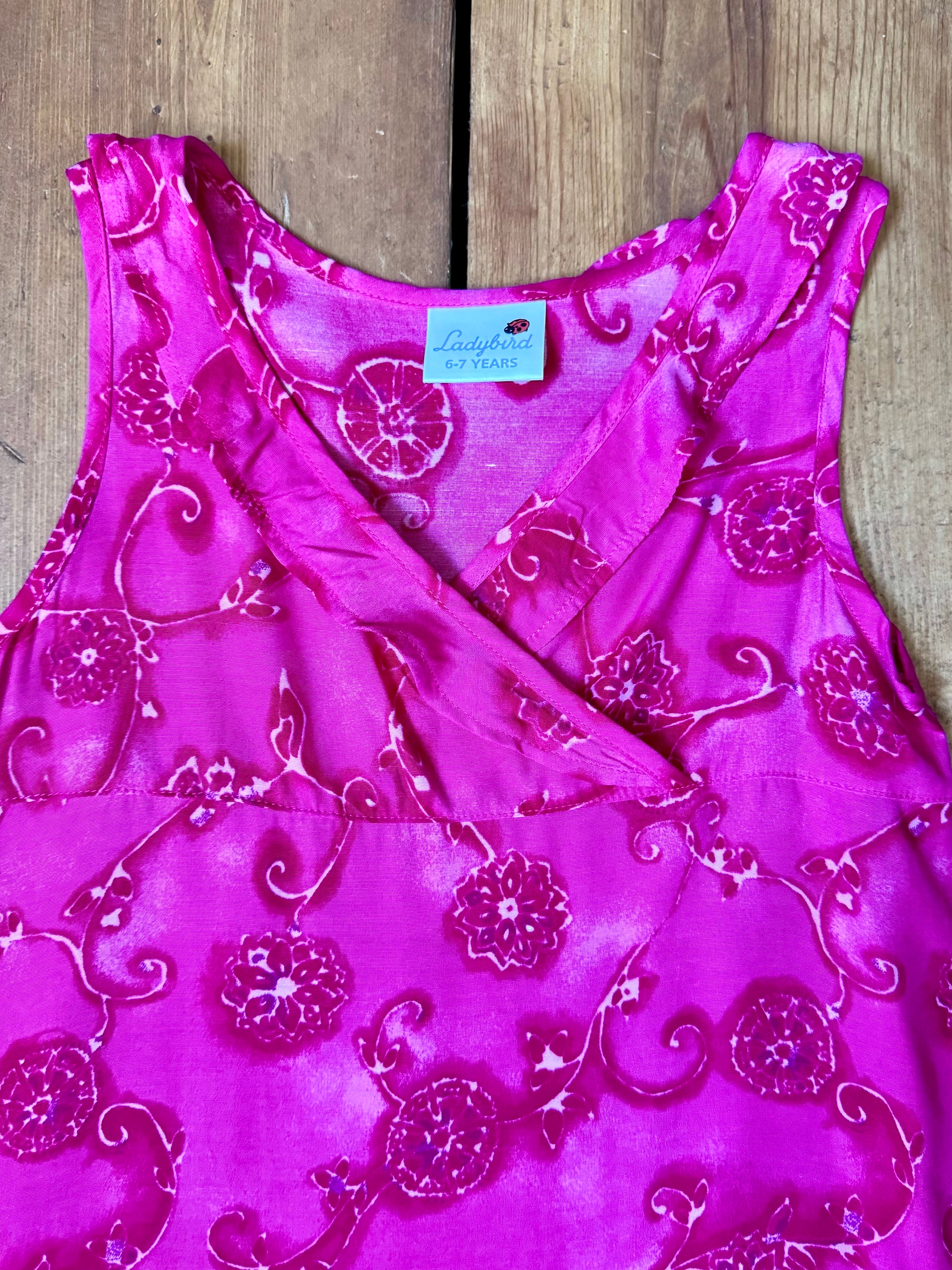 Vintage Y2K fuchsia floral occasion dress for kids. Lightweight 100% viscose with wrap neckline and fluted hem. Handpicked for Bee Tiny kids vintage.