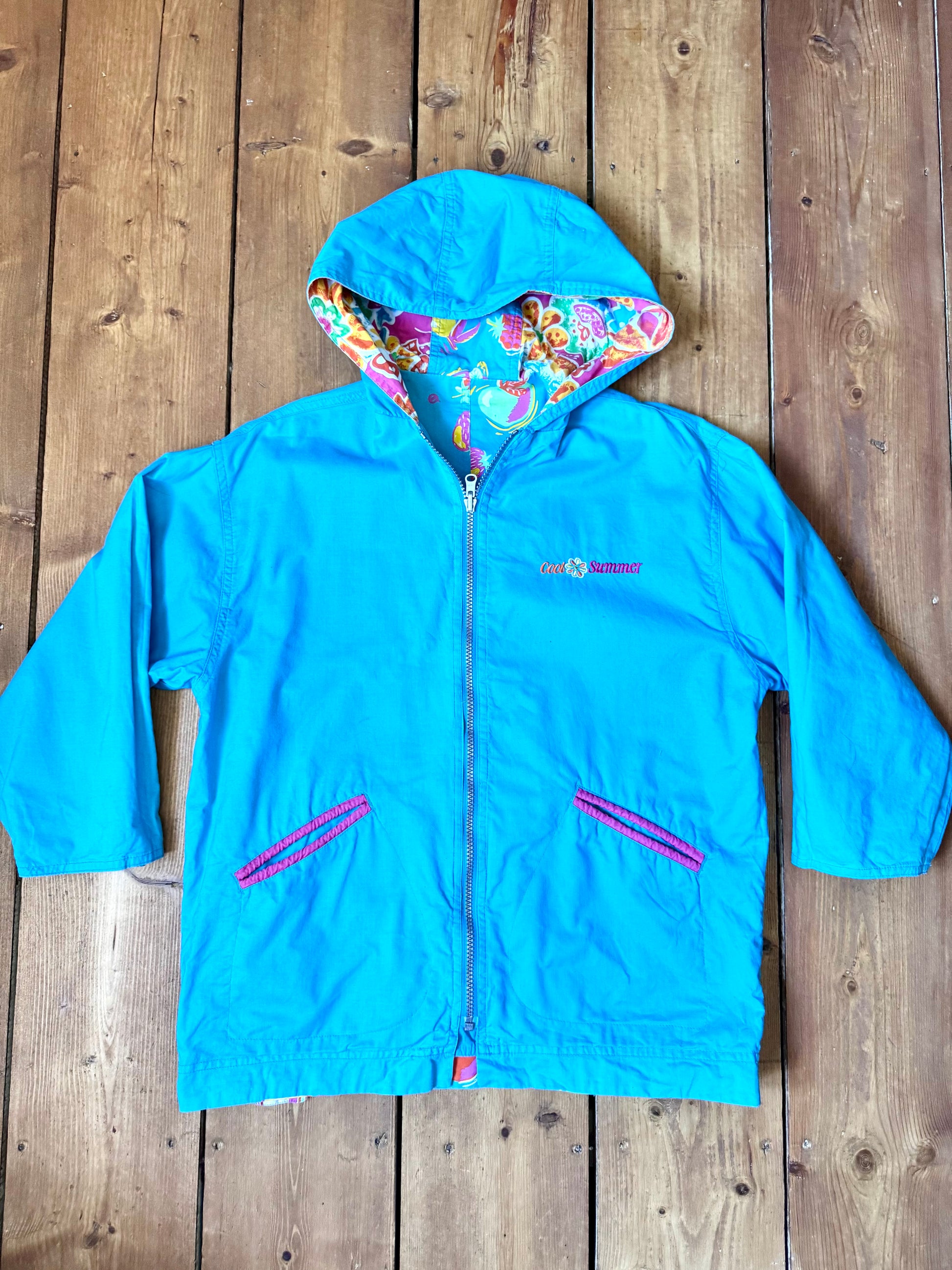 Vintage 90s reversible kids hooded jacket featuring colourful tropical floral prints and a turquoise reverse. Kids vintage lightweight summer coat. Handpicked for Bee Tiny kids vintage.