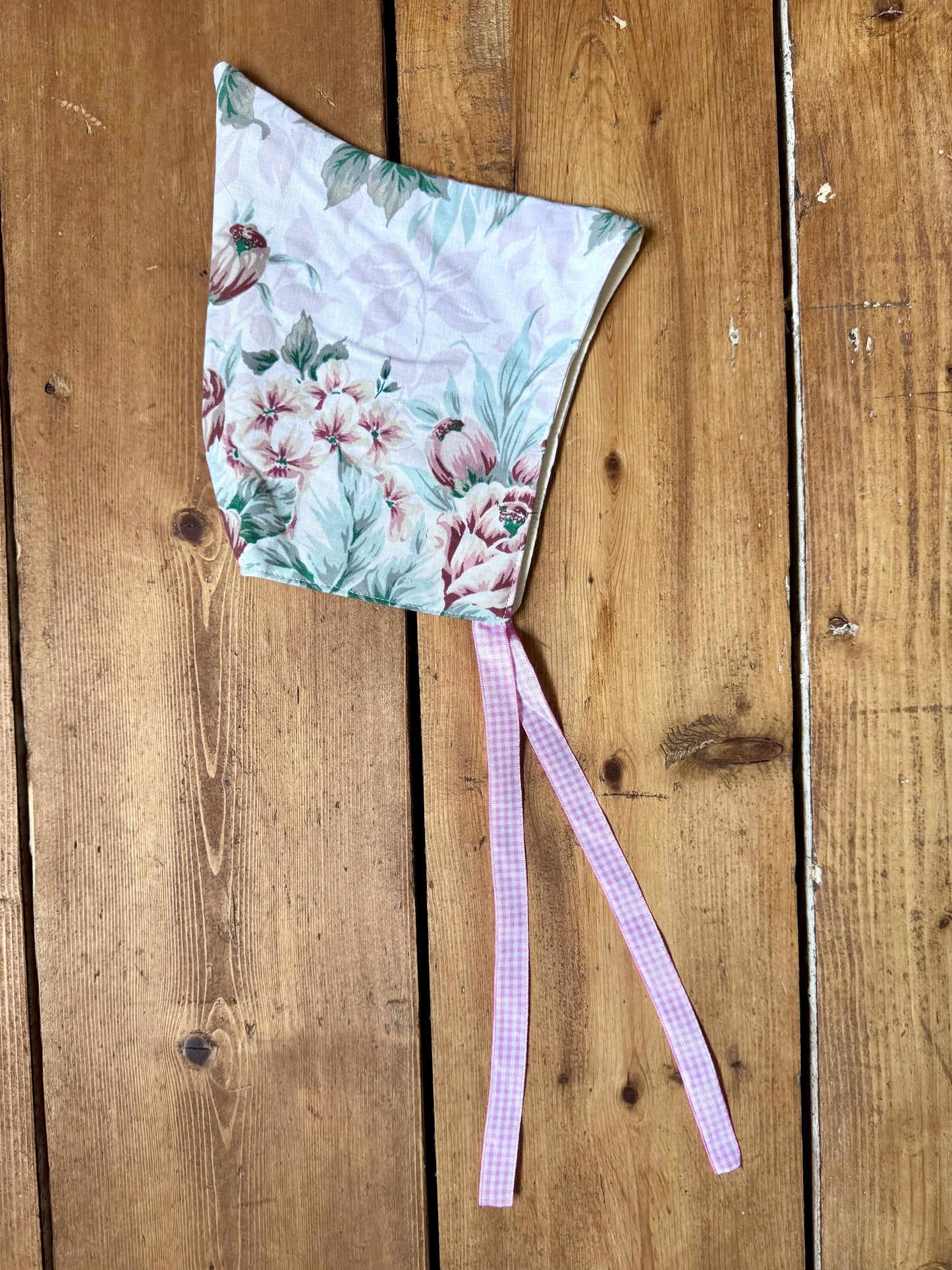 Handmade vintage floral children's set featuring wide-leg trousers and a matching pixie bonnet. One-of-a-kind, sustainably made from rescued fabric. Handmade for Bee Tiny kids vintage.