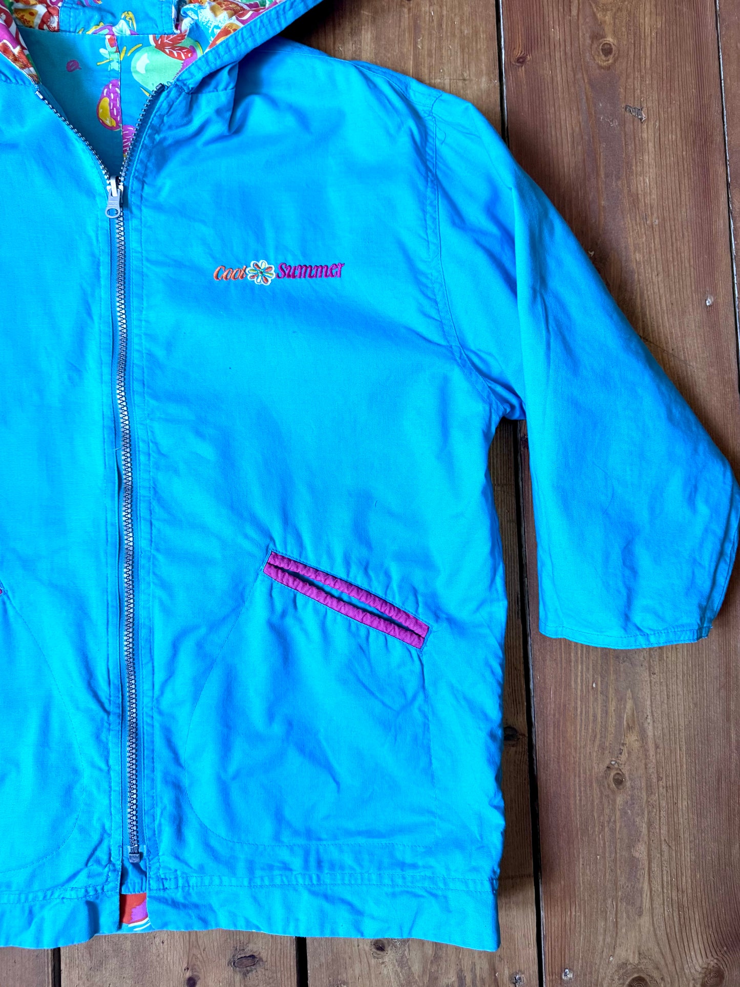 Vintage 90s reversible kids hooded jacket featuring colourful tropical floral prints and a turquoise reverse. Kids vintage lightweight summer coat. Handpicked for Bee Tiny kids vintage.