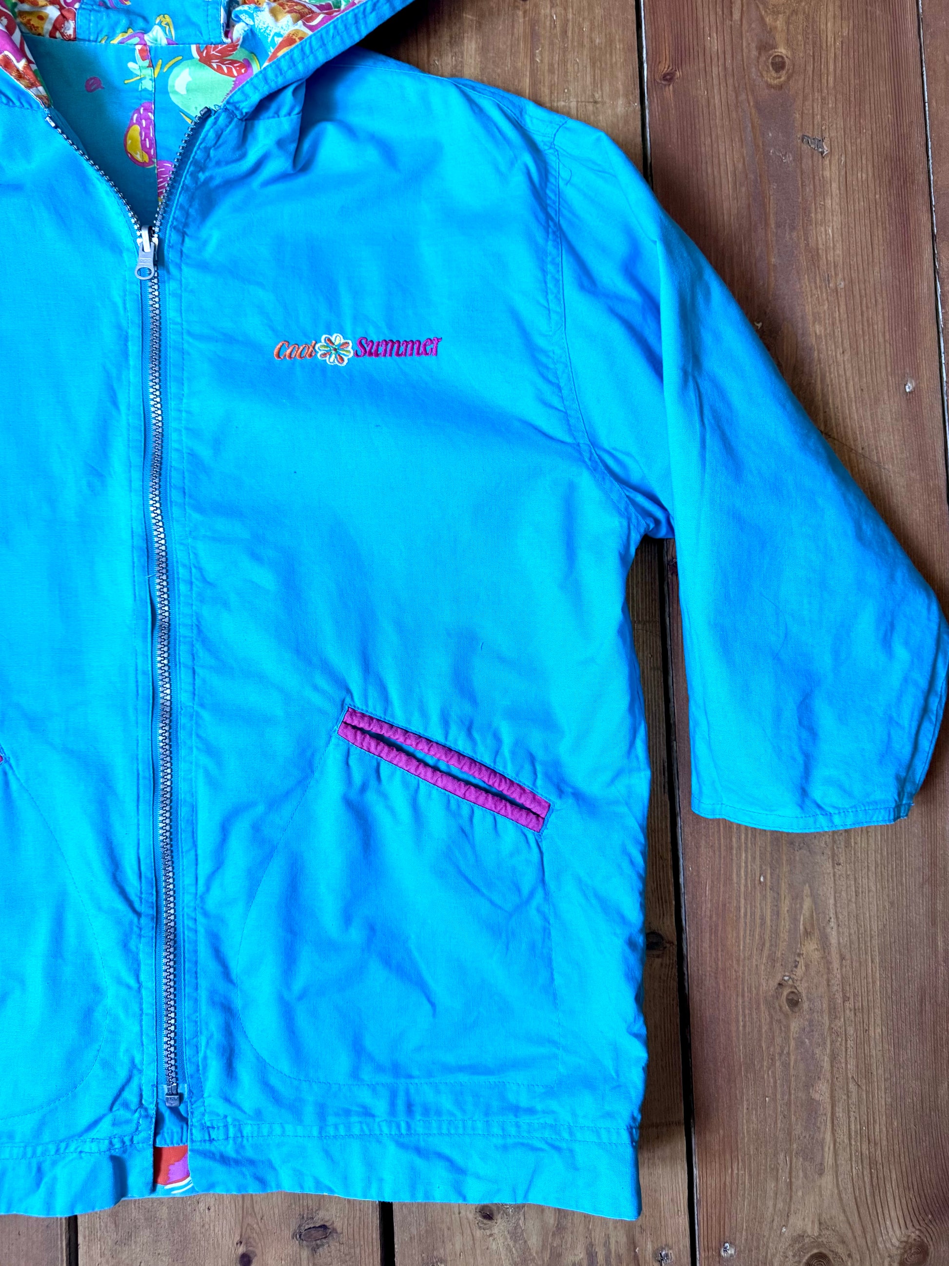 Vintage 90s reversible kids hooded jacket featuring colourful tropical floral prints and a turquoise reverse. Kids vintage lightweight summer coat. Handpicked for Bee Tiny kids vintage.