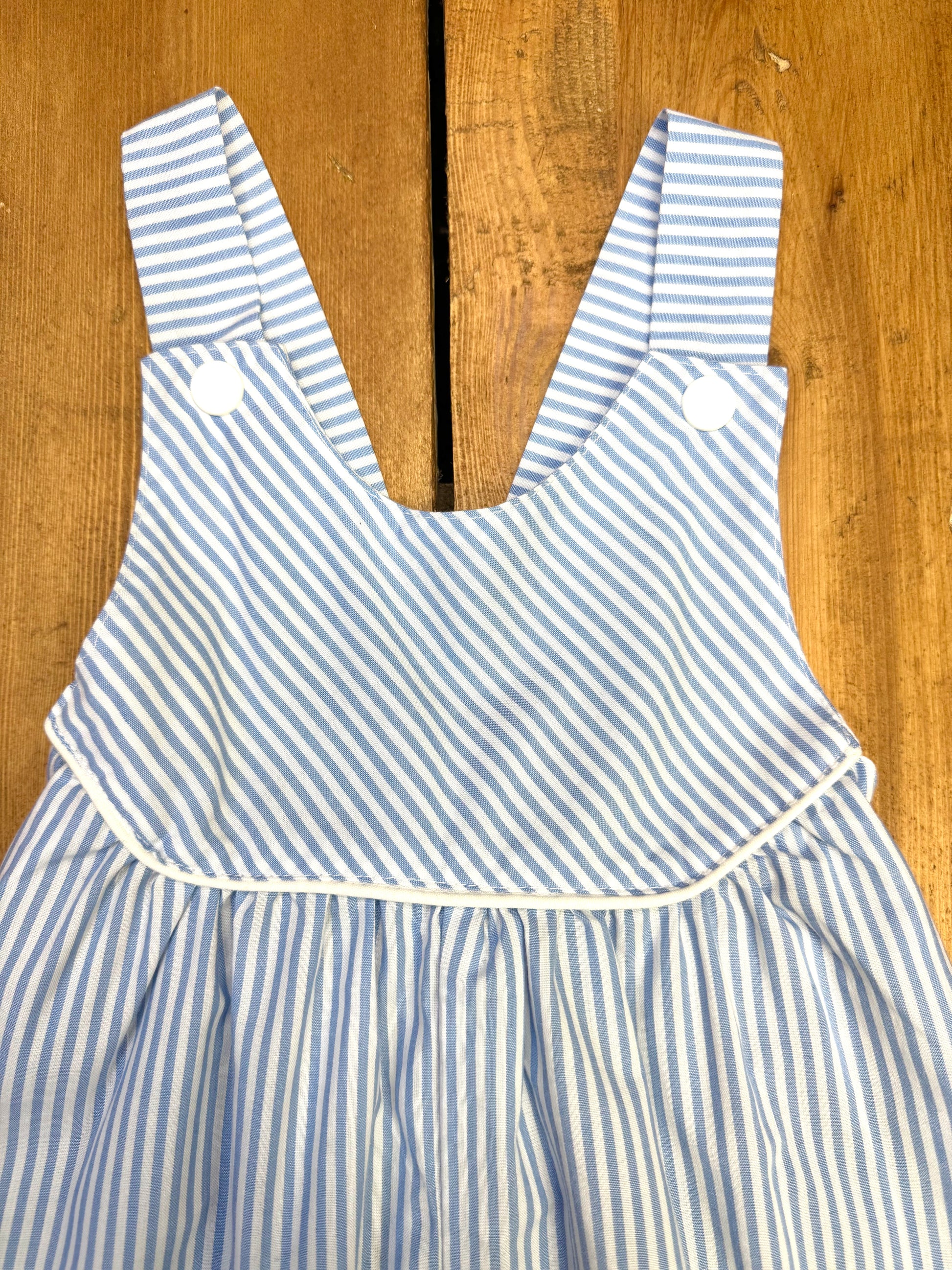 Close up of vintage blue and white striped baby romper